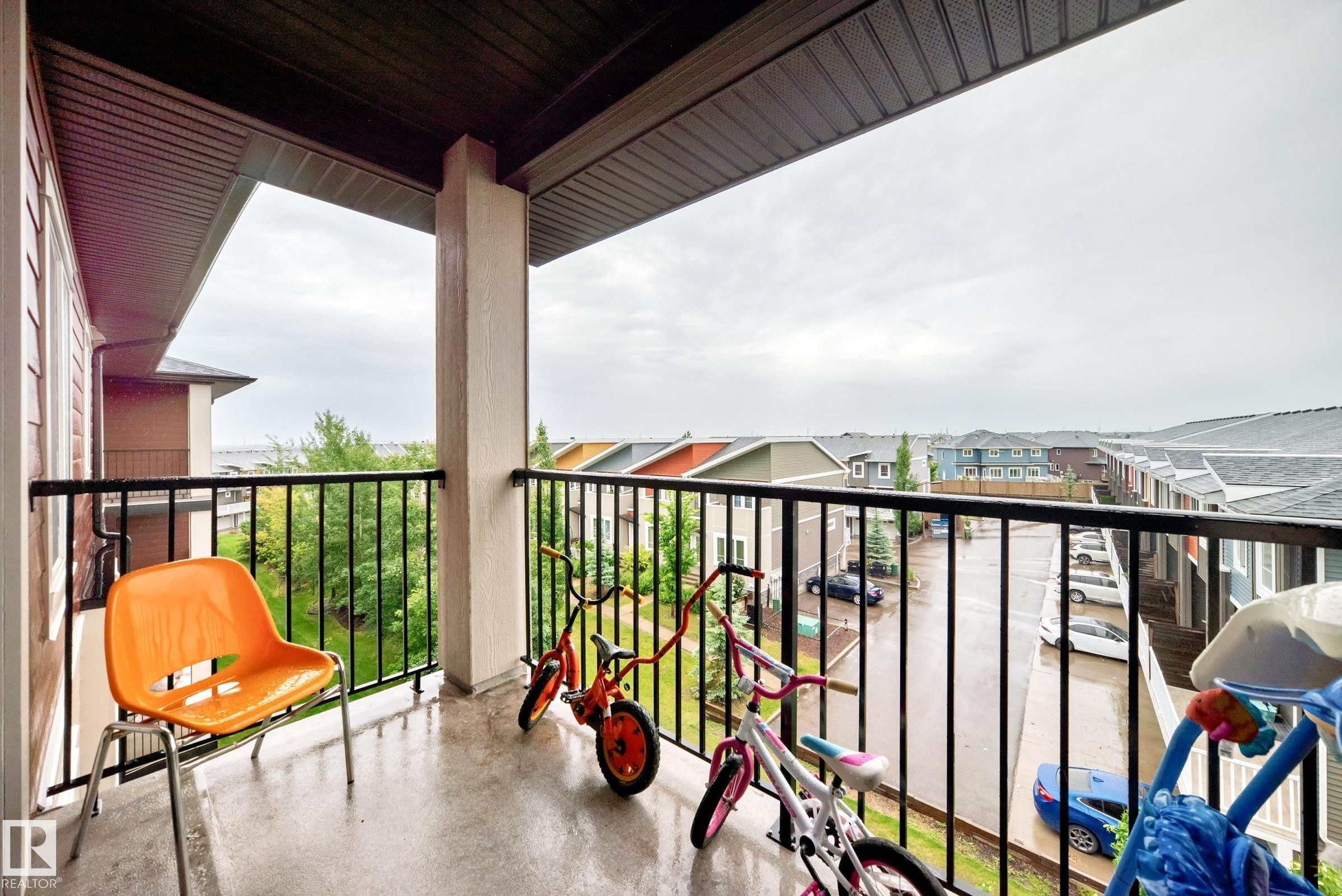Private balcony featuring a concrete floor and a black metal railing - #417 1510 Watt Dr Sw, Edmonton, AB - Outdoor With Balcony With Exterior