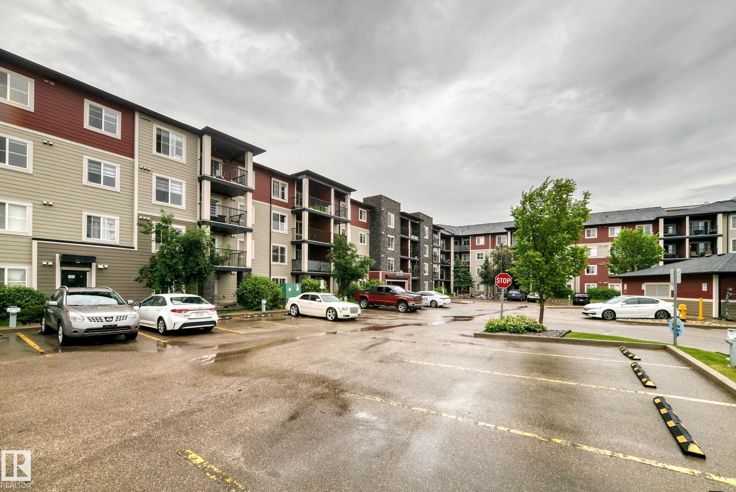 Multi-story residential buildings featuring varied facade materials including siding and stone accents - #417 1510 Watt Dr Sw, Edmonton, AB - Outdoor With Facade