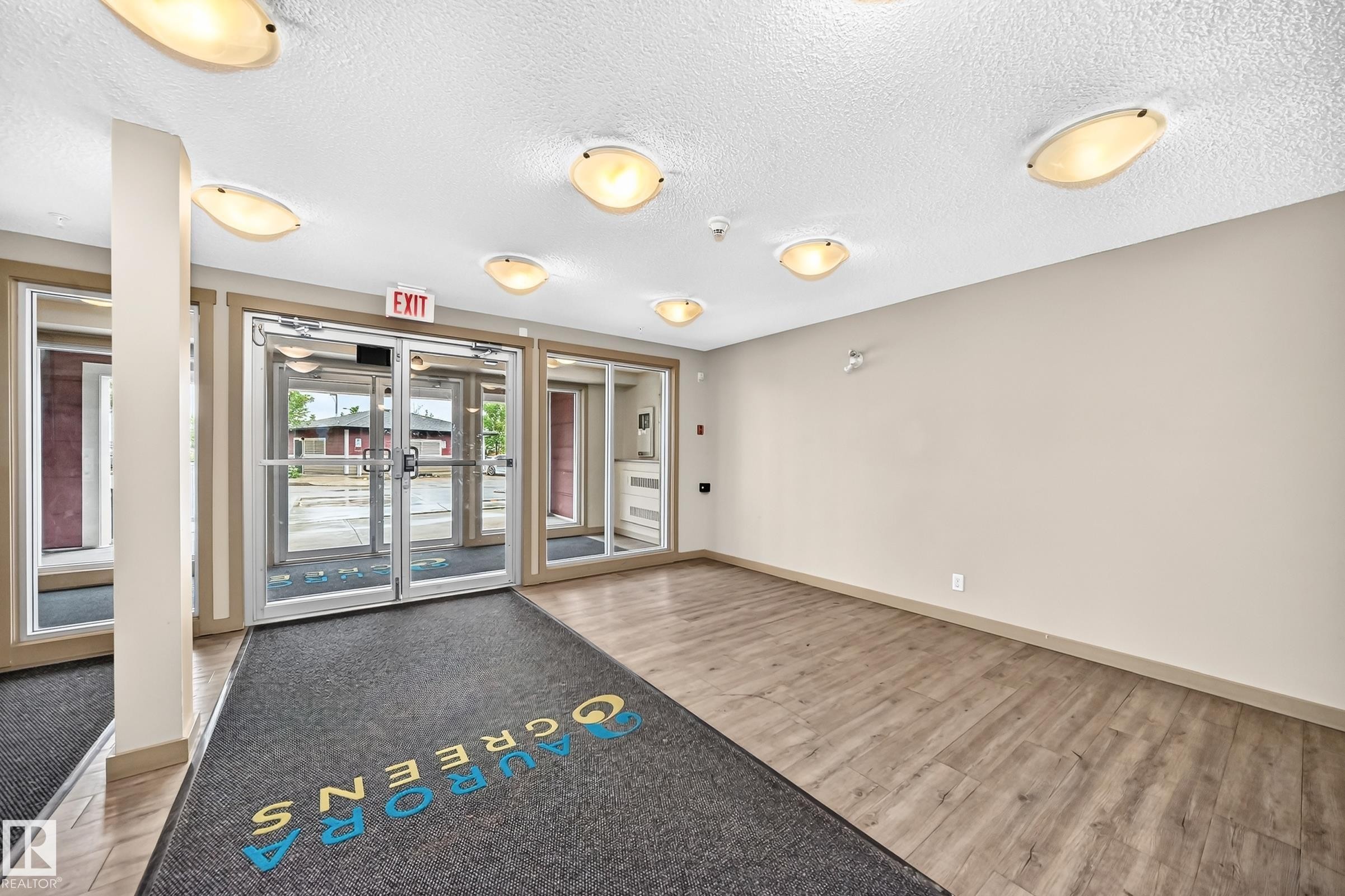 Entryway featuring light wood-finish flooring and neutral wall tones - #417 1510 Watt Dr Sw, Edmonton, AB - Indoor Photo Showing Other Room