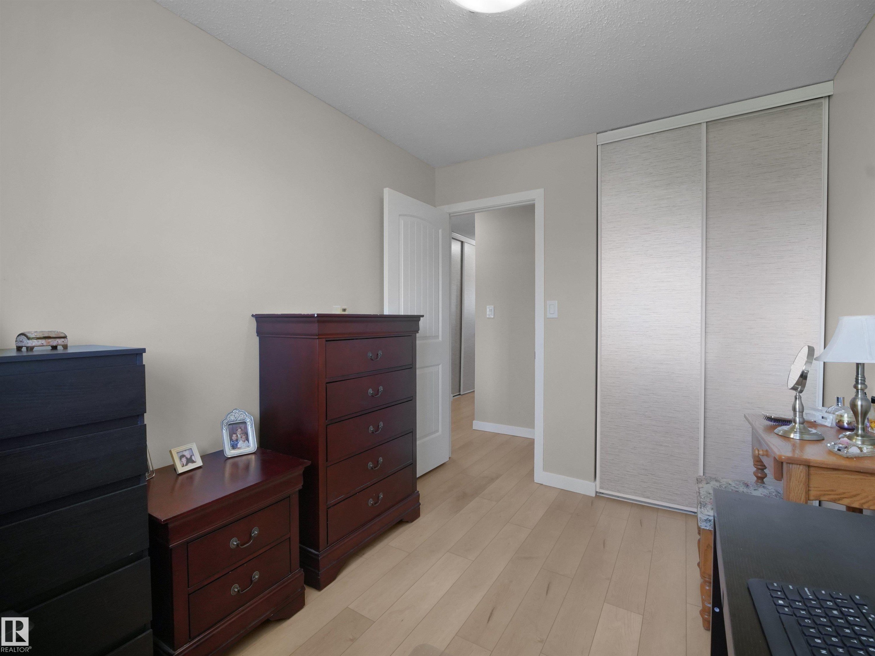 Light wood-finish flooring complements neutral wall paint in this room - 575 Dunluce Road, Edmonton, AB