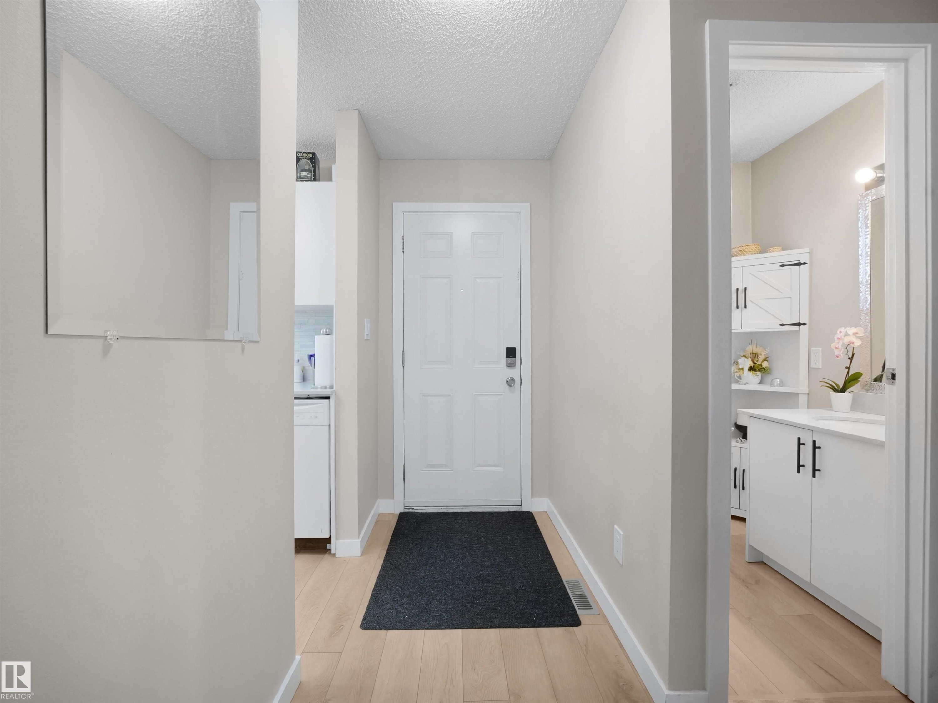 Entryway with wood-finish flooring and a paneled door - 575 Dunluce Road, Edmonton, AB