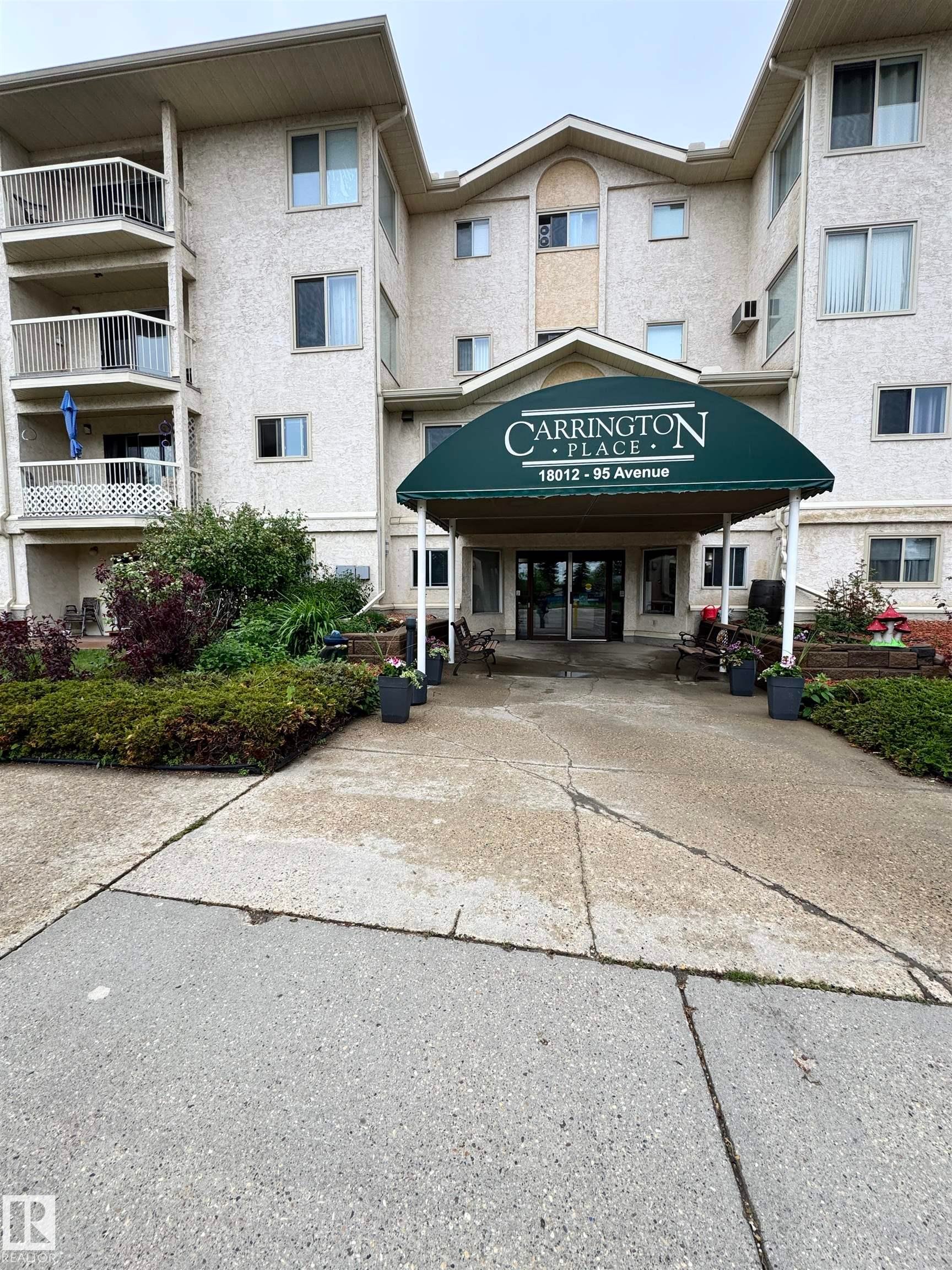 Multi-story residential building featuring a stucco facade and multiple private balconies - 207 18012 95 Avenue, Edmonton, AB