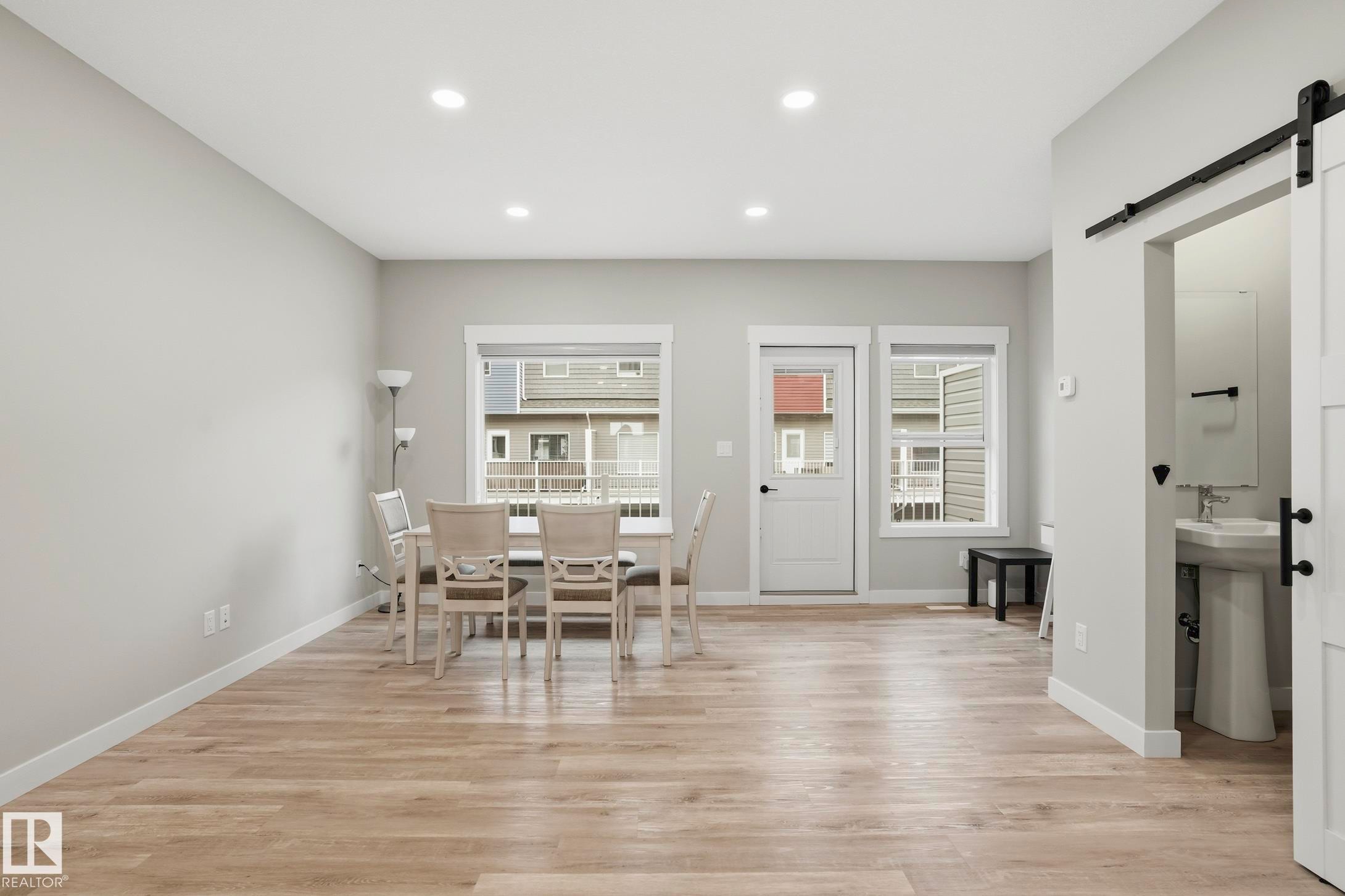 Open-concept interior featuring wood-finish flooring throughout - 36 150 Everitt Dr, St. Albert, AB - Indoor Photo Showing Dining Room