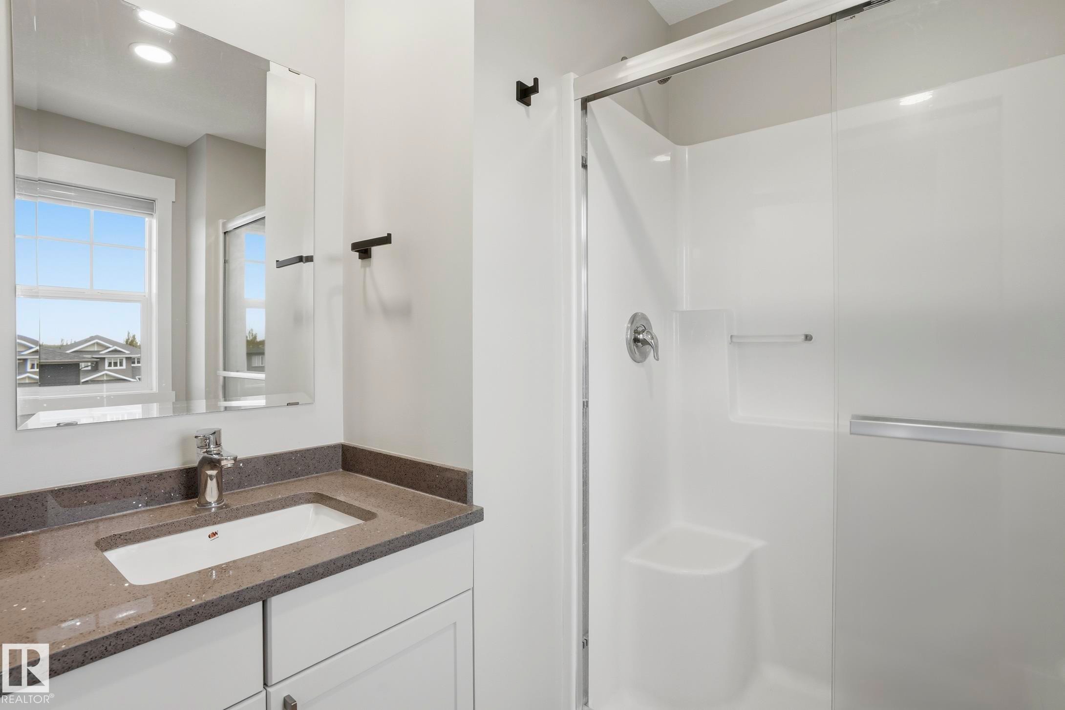 Bathroom featuring a white vanity with a rectangular undermount sink, a gray speckled countertop, and a chrome faucet - 36 150 Everitt Dr, St. Albert, AB - Indoor Photo Showing Bathroom