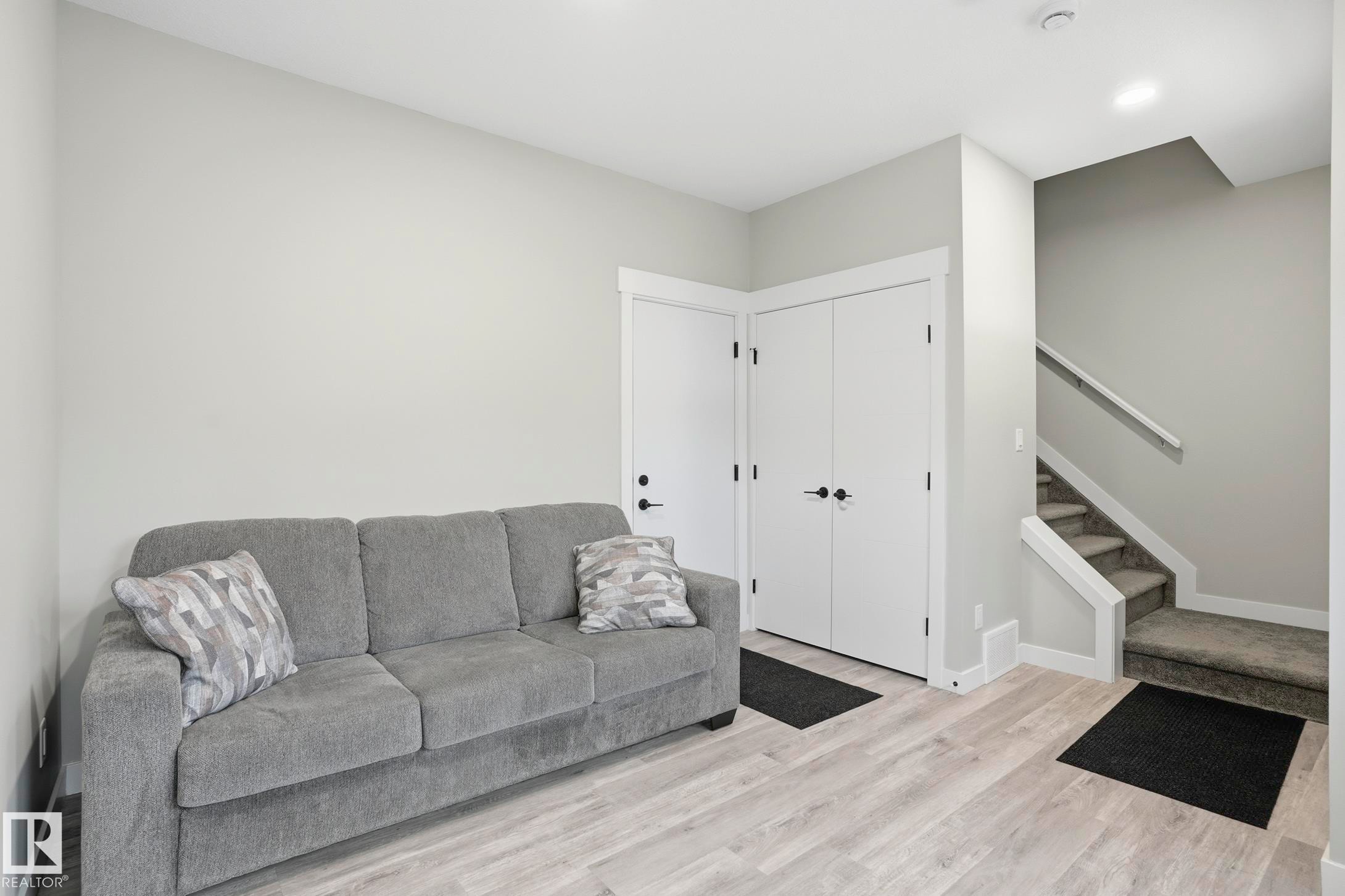 Light wood-finish flooring complements the neutral wall color - 36 150 Everitt Dr, St. Albert, AB - Indoor