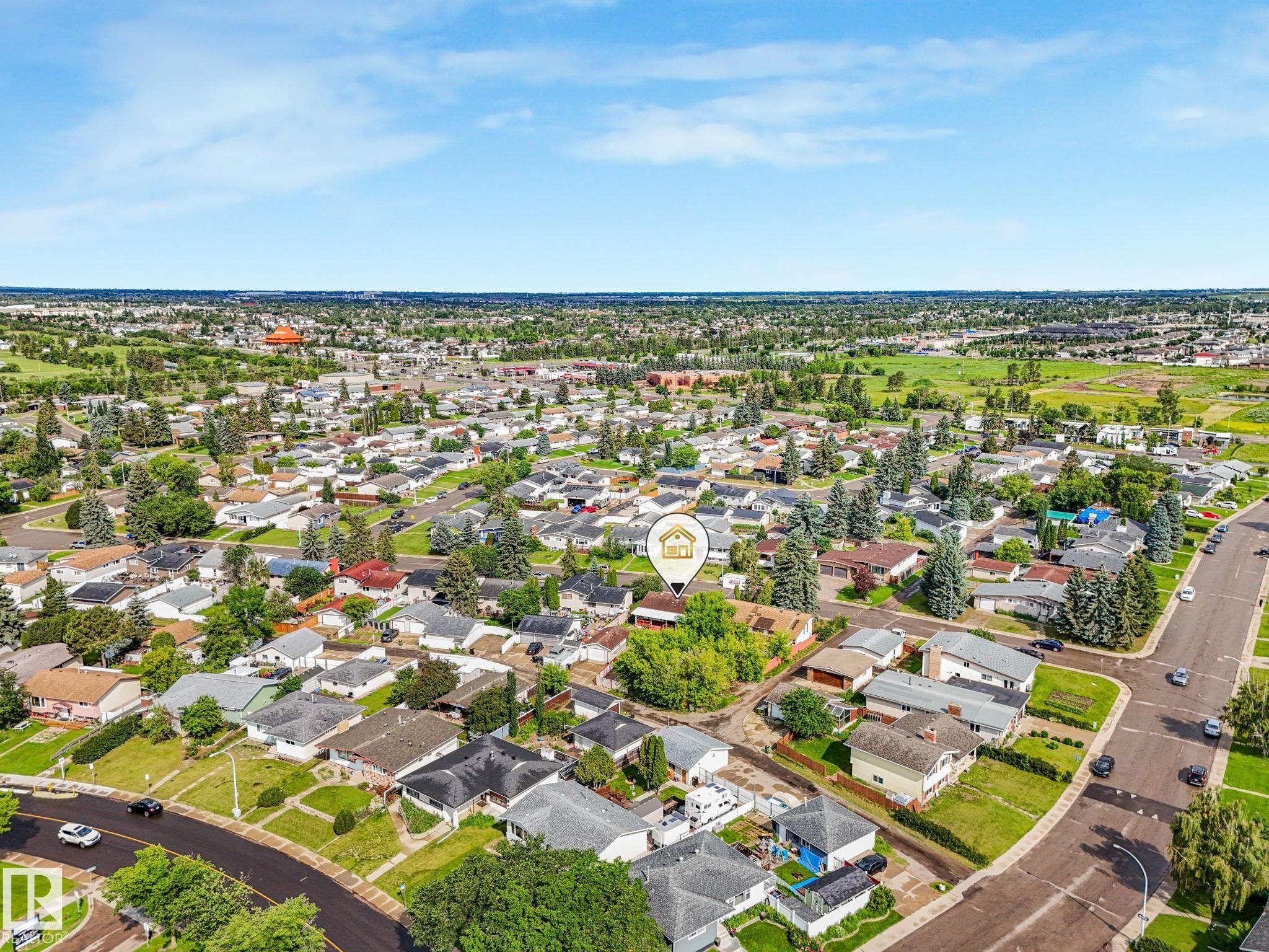 Aerial perspective showcasing a residential neighborhood with a mix of single-family homes and mature landscaping - 9315 151 Avenue, Edmonton, AB
