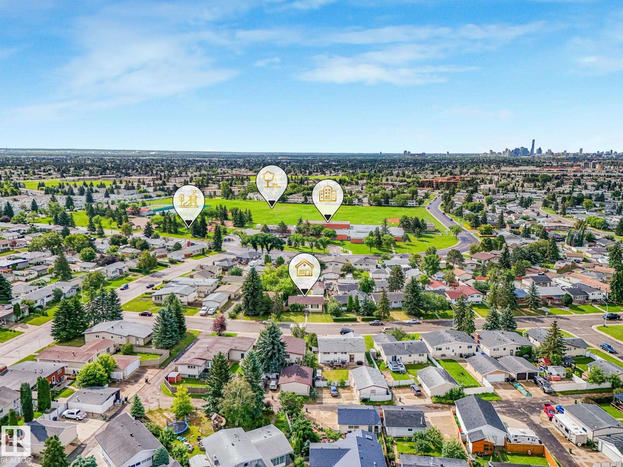 Expansive residential area featuring numerous single-story homes, mature trees, and paved streets - 9315 151 Avenue, Edmonton, AB