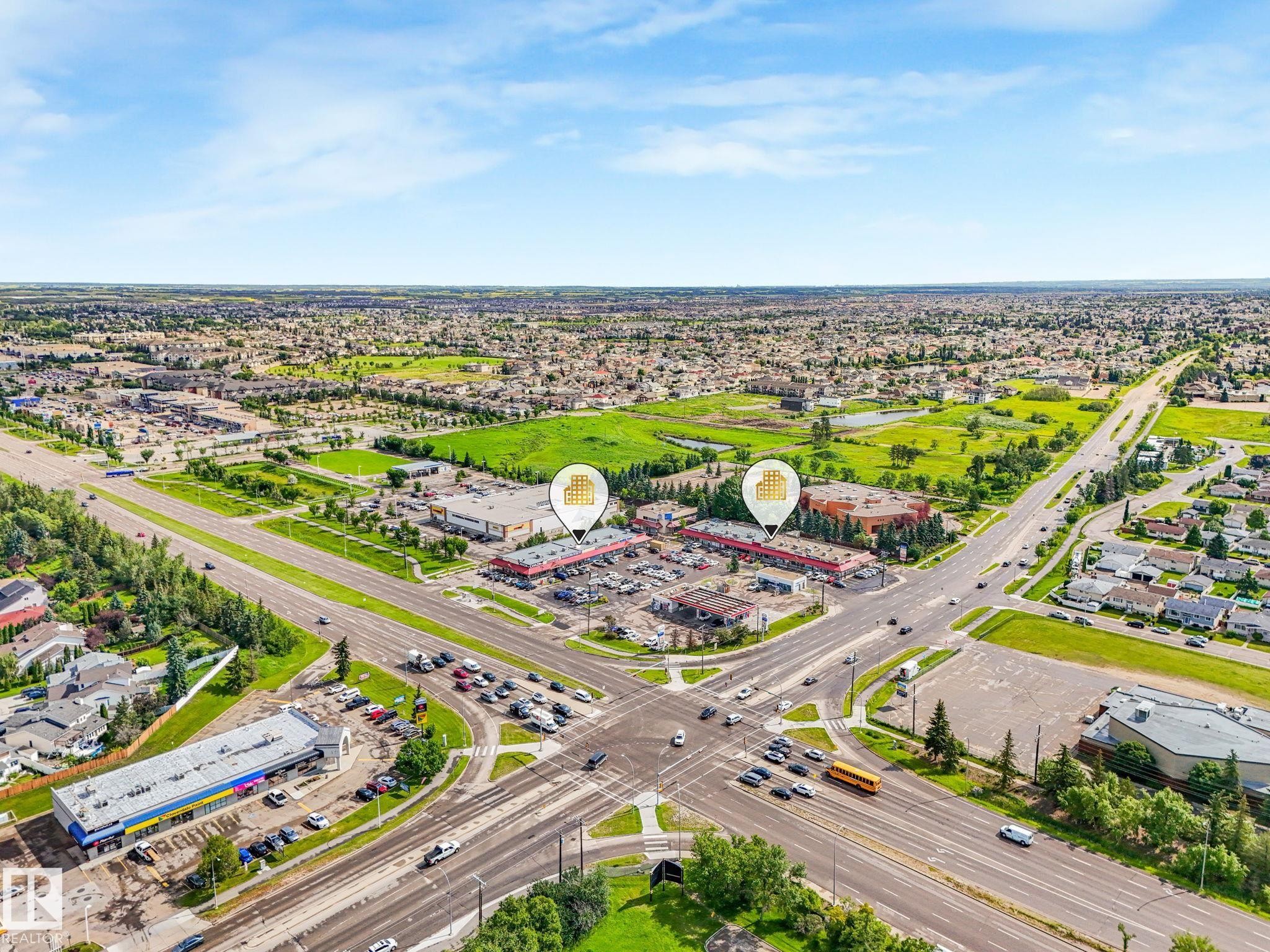 Aerial perspective showcasing commercial properties at a central intersection - 9315 151 Avenue, Edmonton, AB