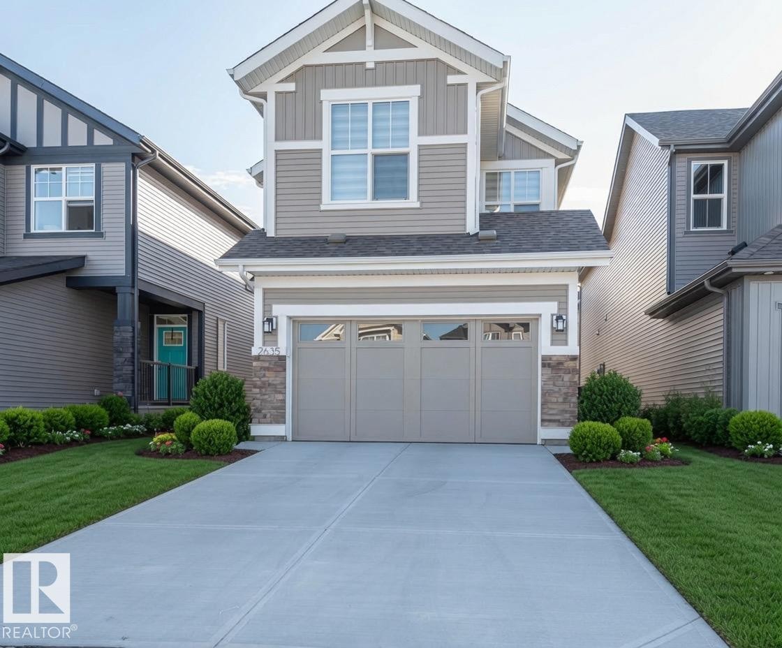 Contemporary two-story residence featuring siding and stone accents - 2635 Donaghey Crescent, Edmonton, AB