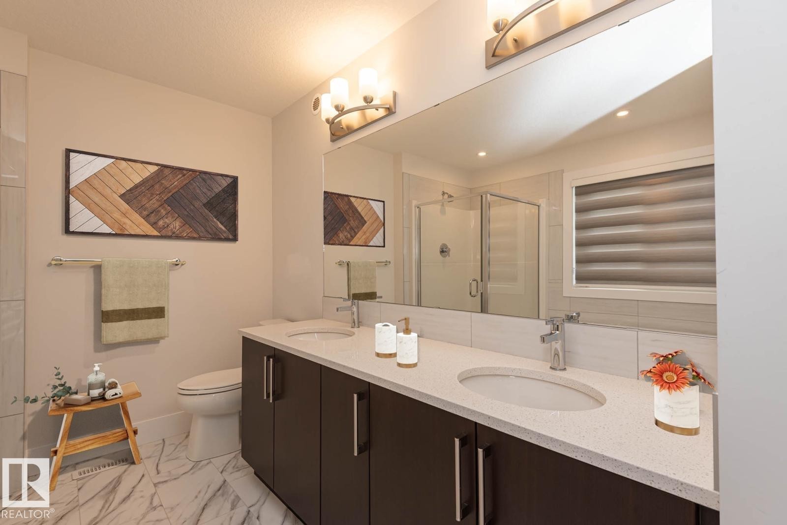 Dual sink vanity with dark wood-finish cabinetry and light-toned countertops - 2635 Donaghey Crescent, Edmonton, AB