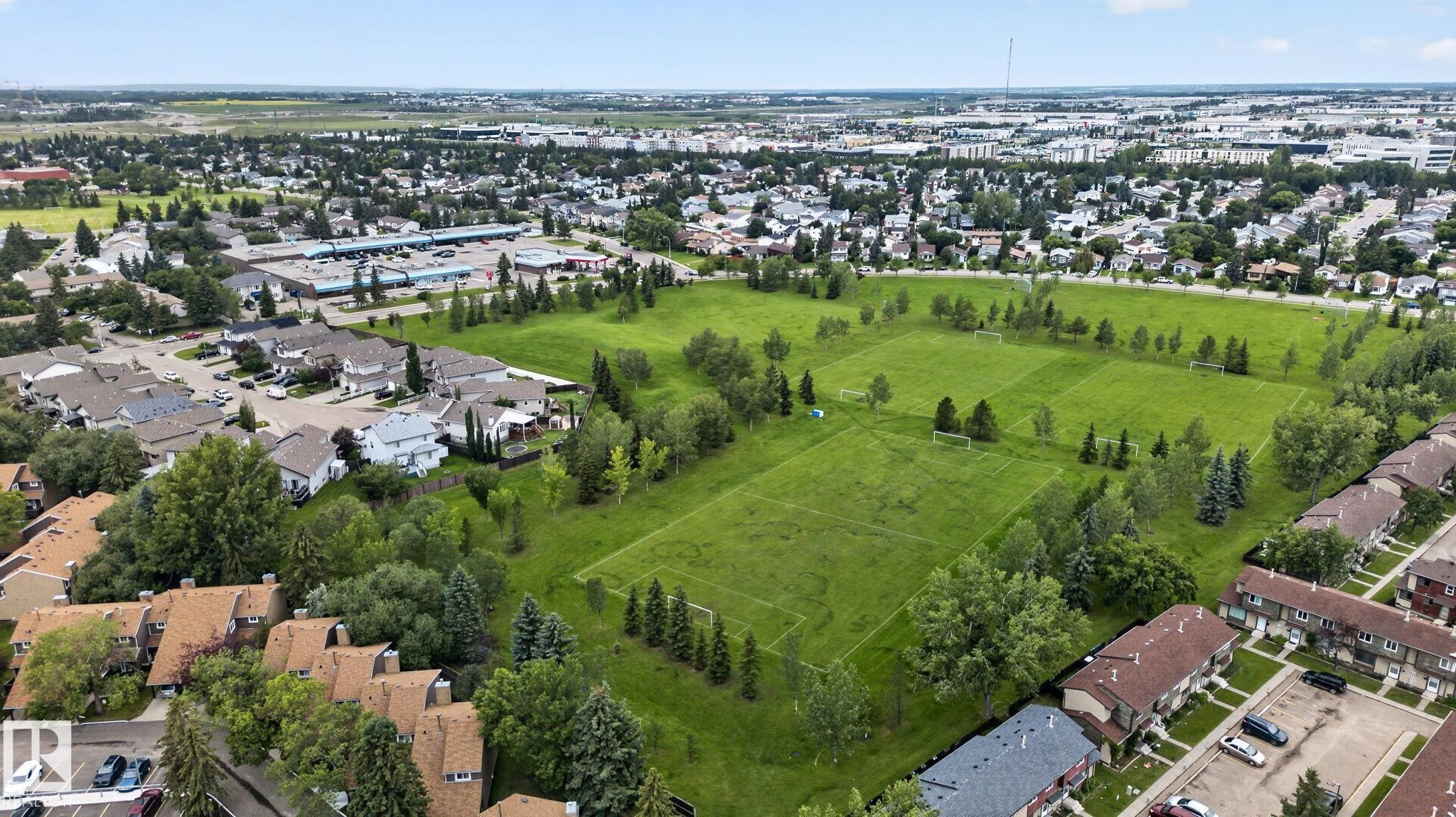 Expansive green spaces featuring multiple sports fields and mature trees - 9503 180A Street Nw, Edmonton, AB - Outdoor With View