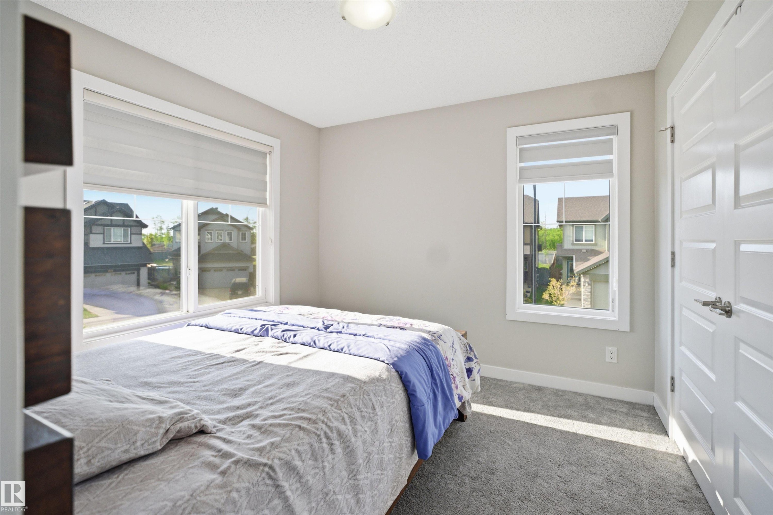 Carpeted room with neutral wall paint and white trim - 1234 Daniels Crescent, Edmonton, AB - Indoor Photo Showing Bedroom