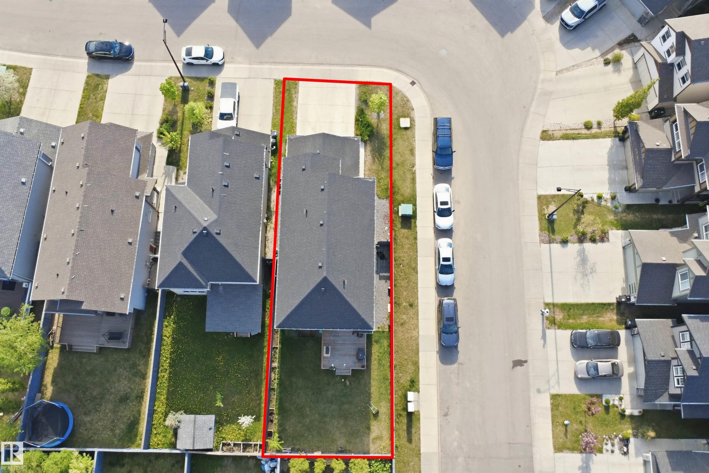 Expansive property featuring a paved driveway, established lawn, and a rear deck - 1234 Daniels Crescent, Edmonton, AB - Other