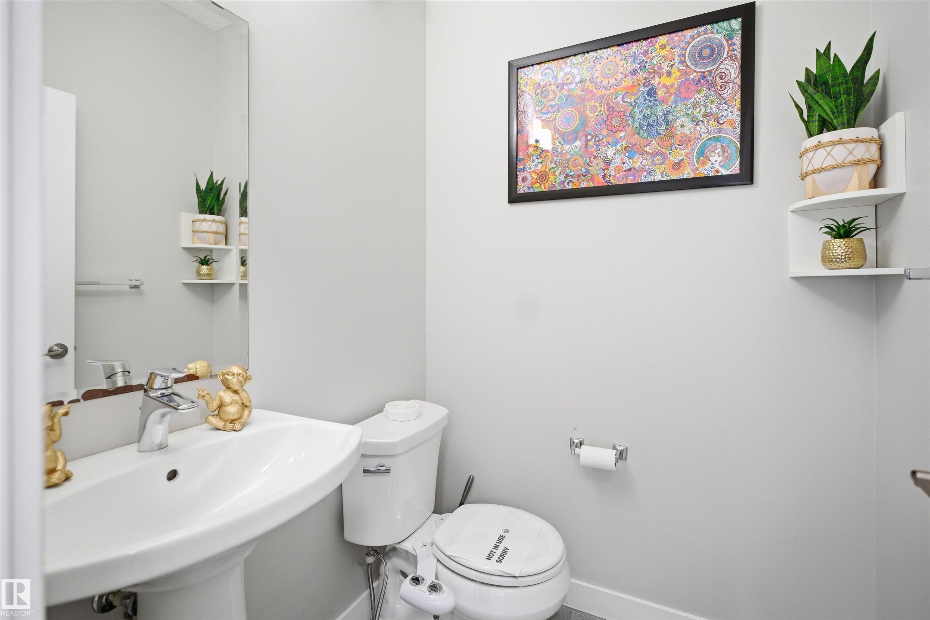 Pedestal sink with chrome faucet, large wall mirror, and light gray wall paint - 1234 Daniels Crescent, Edmonton, AB - Indoor Photo Showing Bathroom