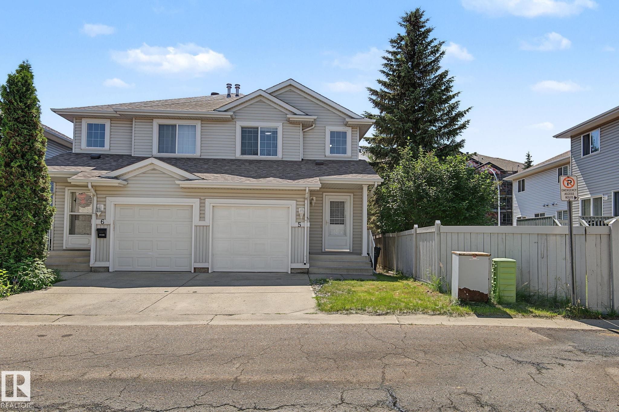 Two-story townhouse with light-colored siding - 5 14603 Miller Boulevard, Edmonton, AB