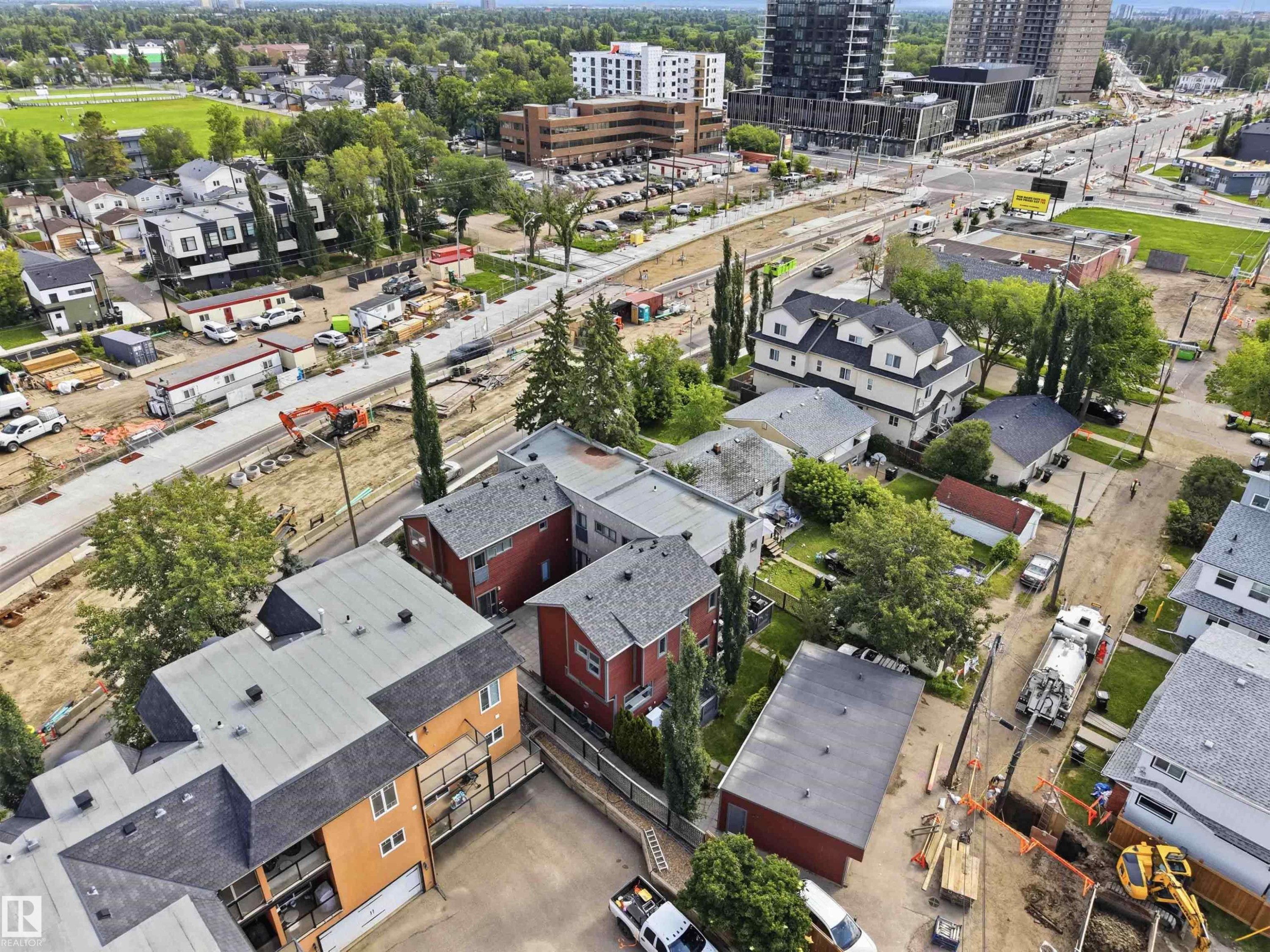 Aerial perspective showcasing a mixed residential and commercial area with multiple properties featuring varying architectural styles and rooflines - #1 14315 Stony Plain Nw, Edmonton, AB - Outdoor With View