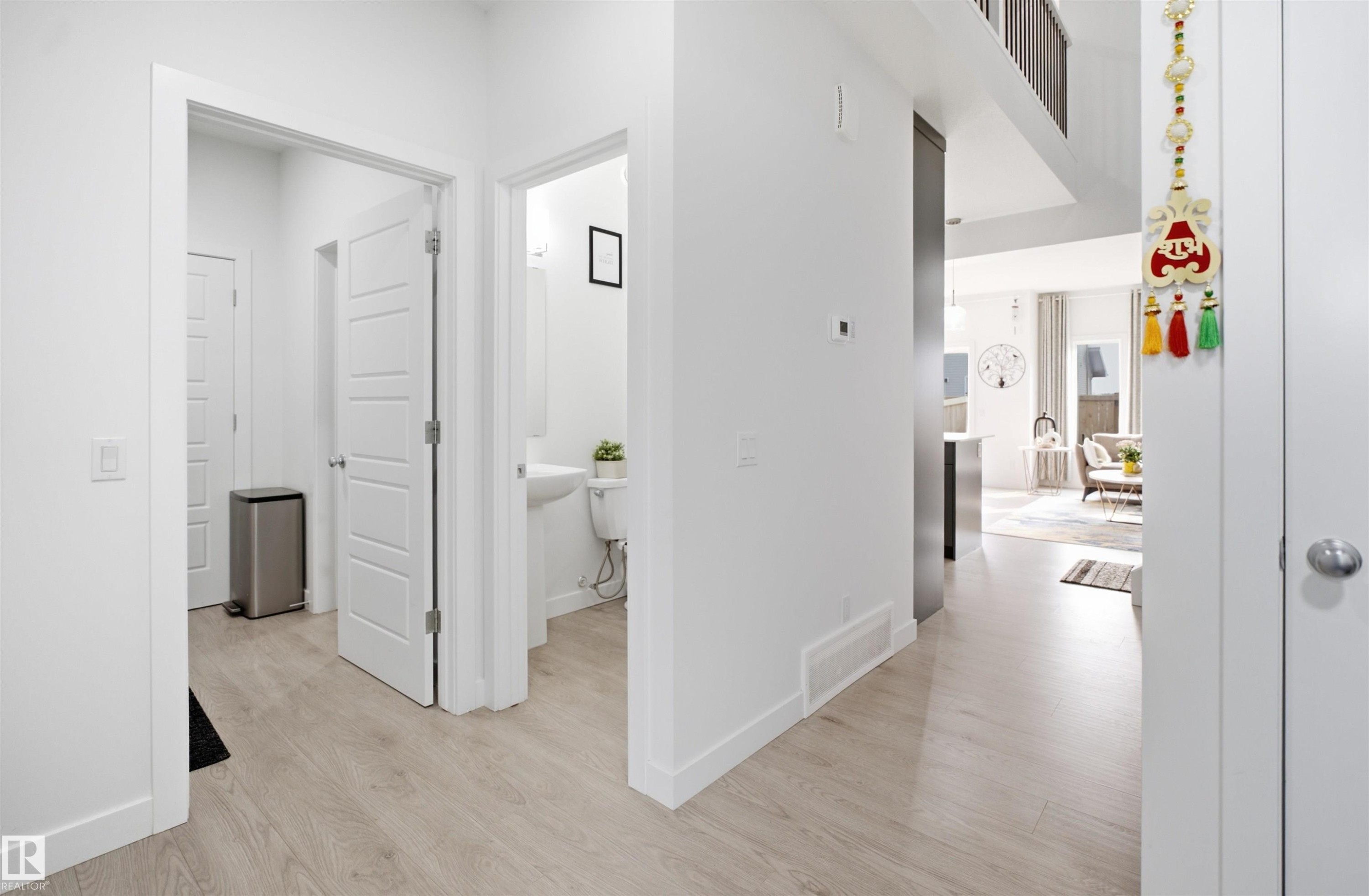 Bright hallway featuring light wood-finish flooring and crisp white walls - 2508 193 Street Nw, Edmonton, AB - Indoor Photo Showing Other Room