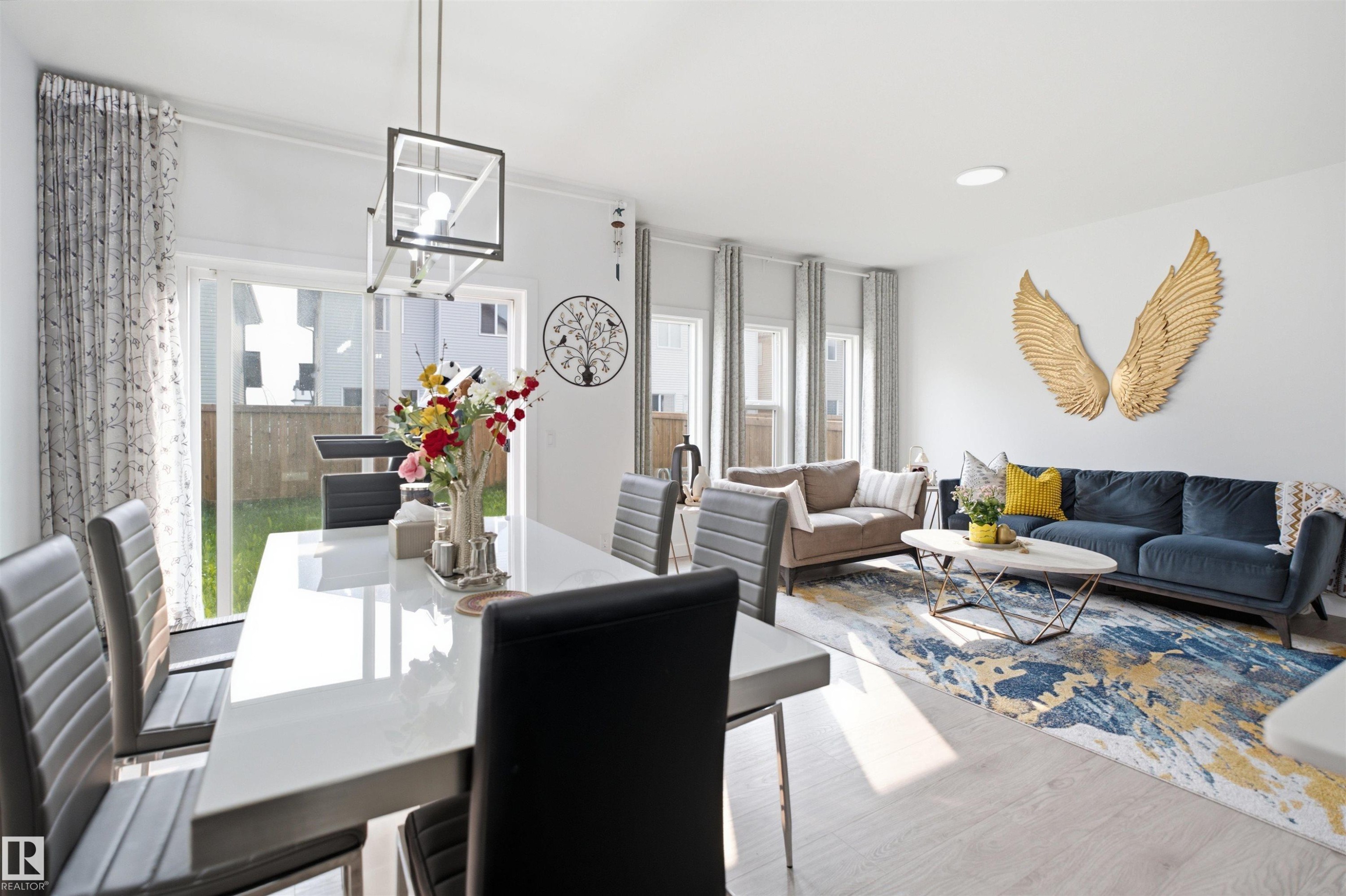 Open-concept living and dining area featuring light wood-finish flooring - 2508 193 Street Nw, Edmonton, AB - Indoor Photo Showing Living Room