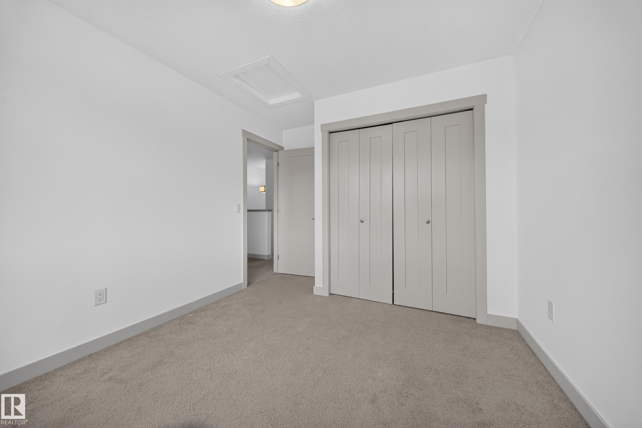 Neutral-toned carpeting paired with white walls - 227 Cy Becker Blvd, Edmonton, AB