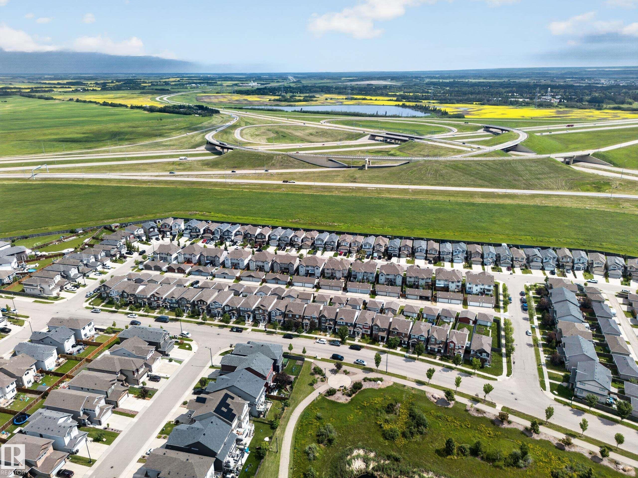 Aerial perspective showcasing a developed residential neighborhood with structured street layouts - 227 Cy Becker Blvd, Edmonton, AB