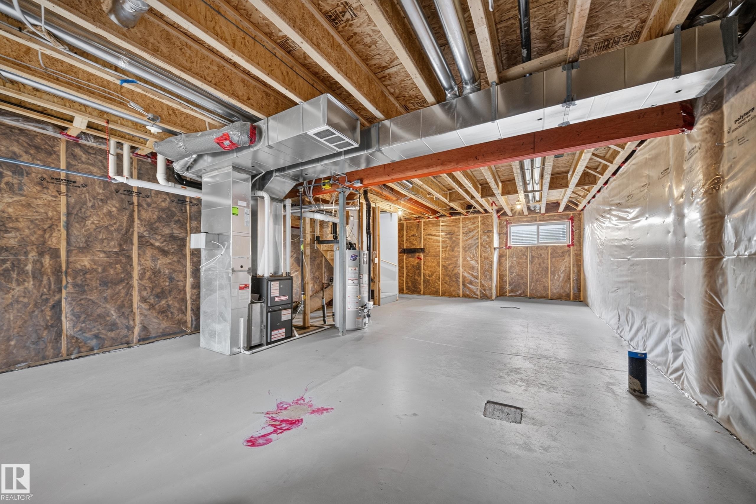 Unfinished basement featuring exposed wood framing, insulated walls, and a painted concrete floor - 227 Cy Becker Blvd, Edmonton, AB