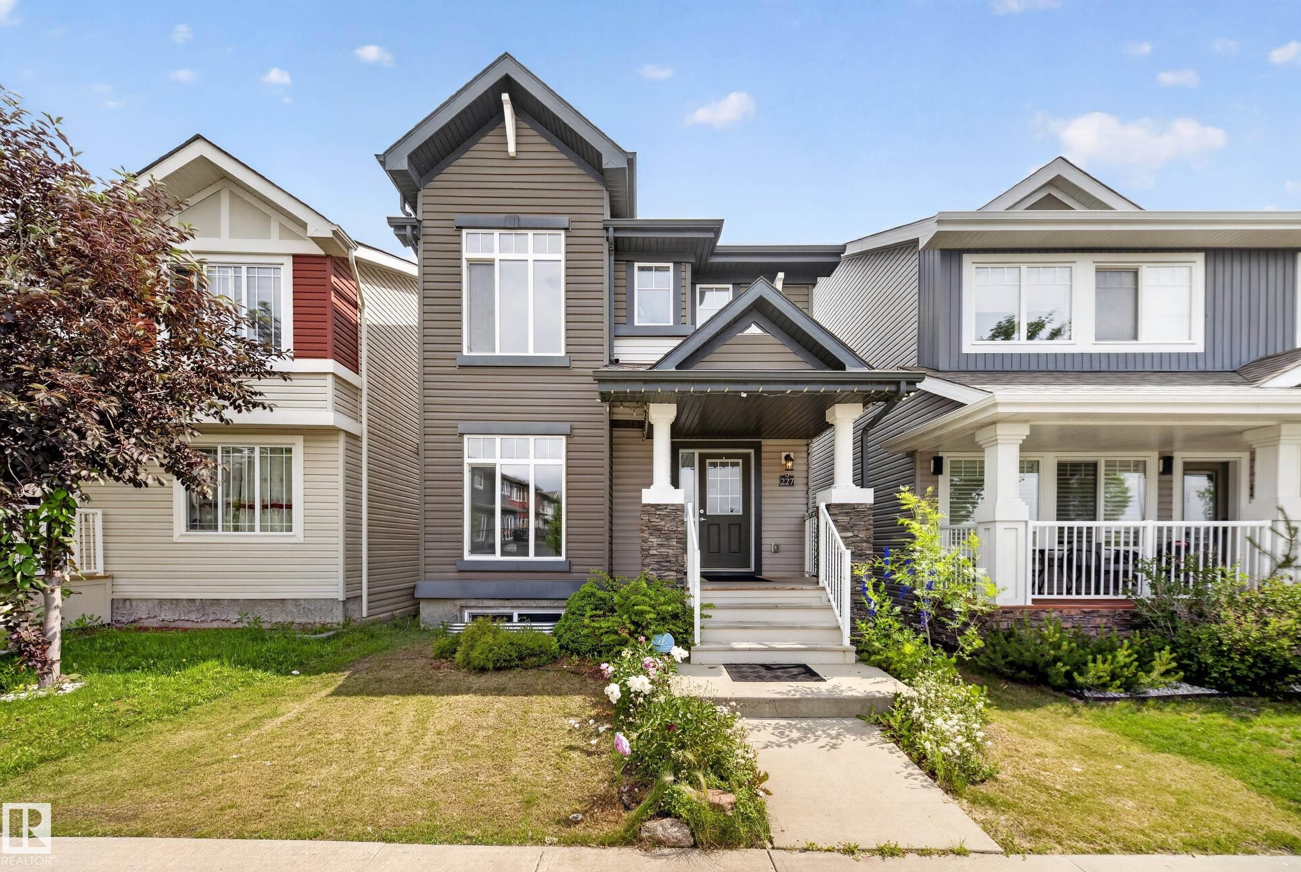 Contemporary multi-level exterior with dark horizontal siding - 227 Cy Becker Blvd, Edmonton, AB