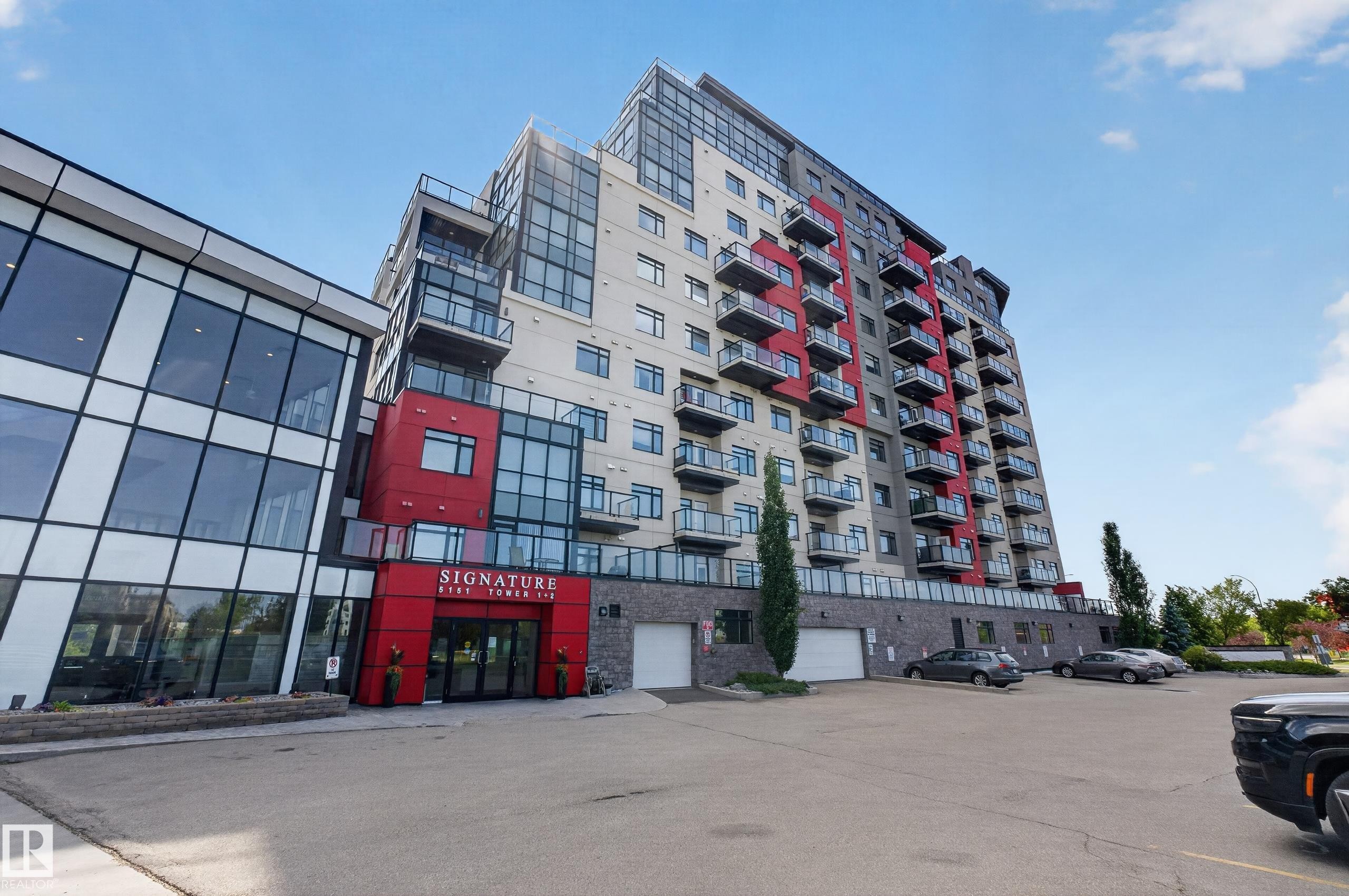 Modern high-rise building with a distinctive red and grey facade - 706 5151 Windermere Boulevard, Edmonton, AB