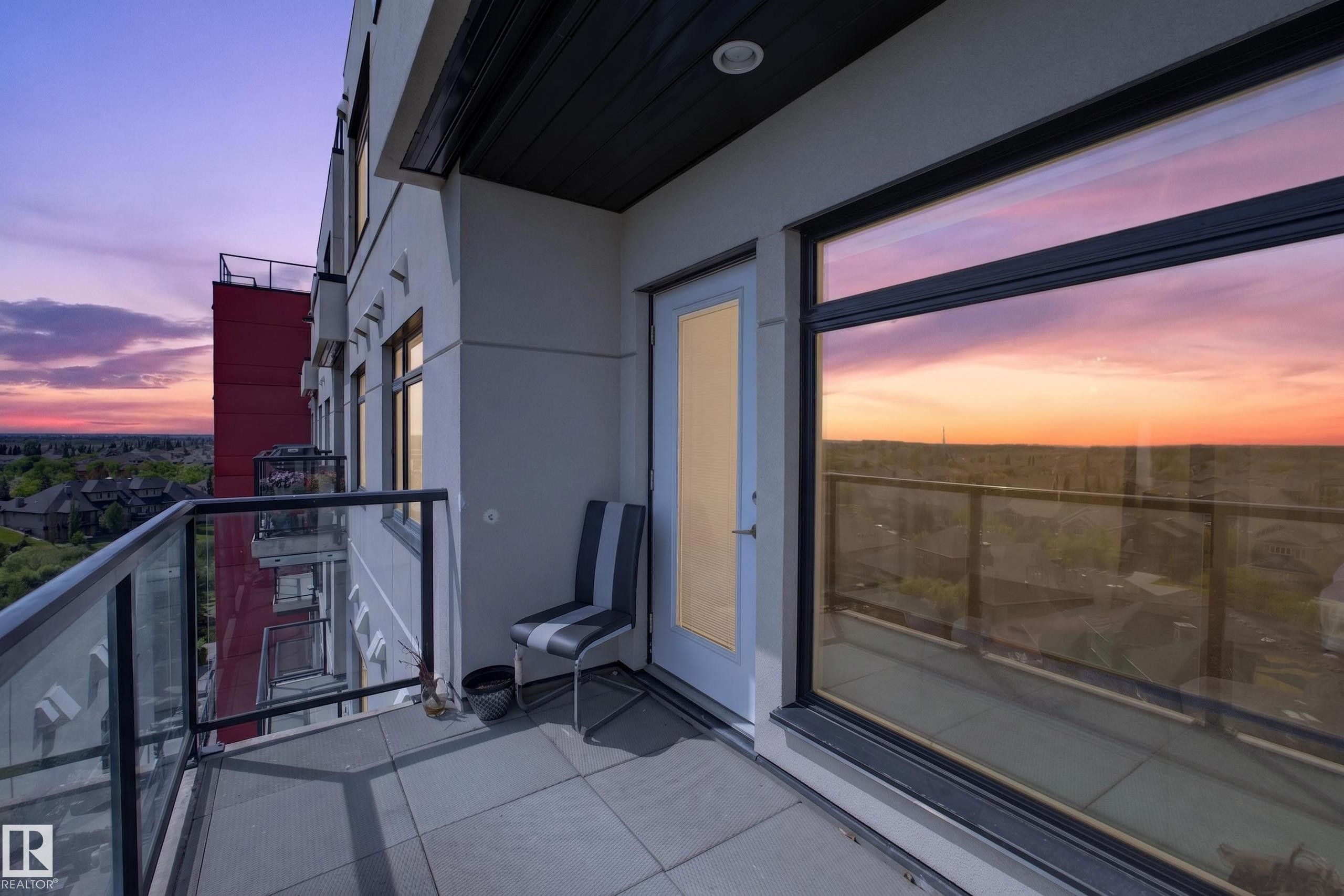 Private balcony with a large glass railing, offering expansive open-air exposure - 706 5151 Windermere Boulevard, Edmonton, AB