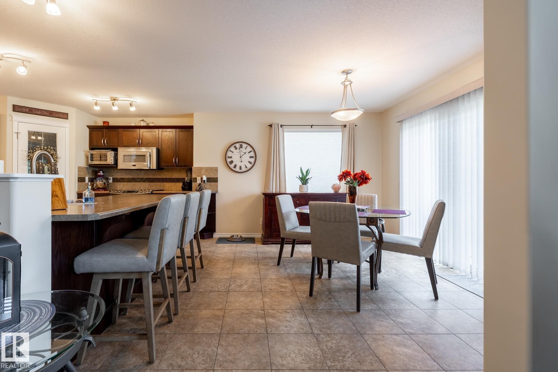 Open concept kitchen and dining area with tile flooring - 5820 7 Avenue Sw, Edmonton, AB - Indoor Photo Showing Dining Room