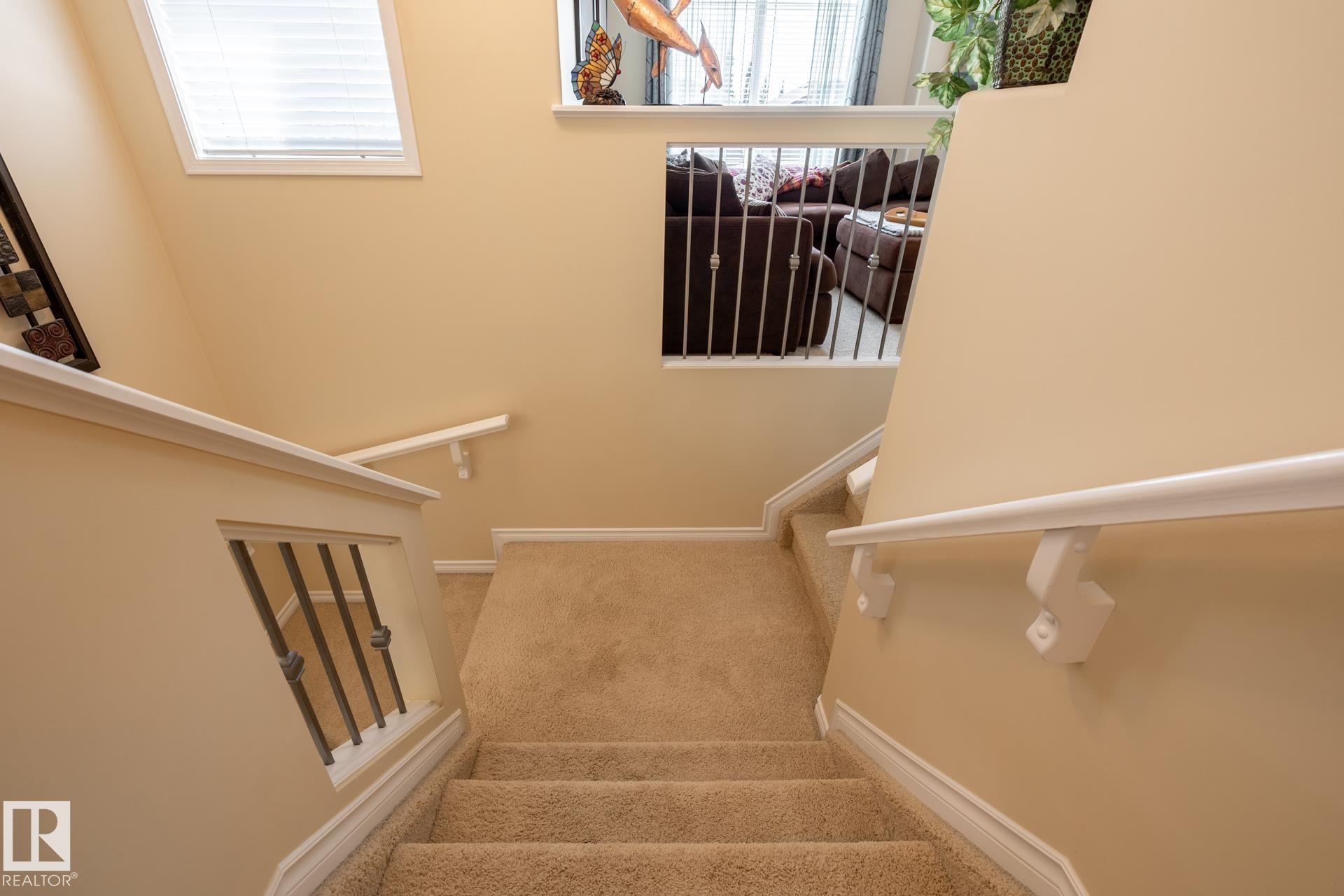 Carpeted staircase with white handrails and painted balusters - 5820 7 Avenue Sw, Edmonton, AB - Indoor Photo Showing Other Room