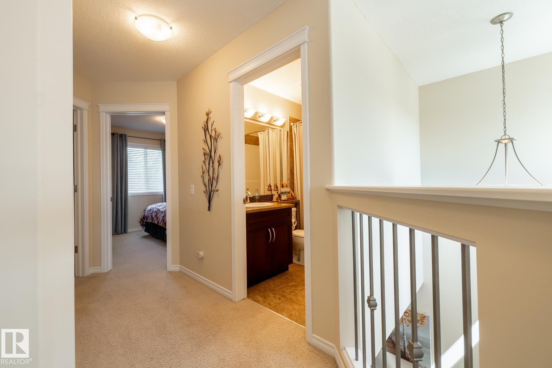Upper-level hallway with carpet flooring and light beige wall paint - 5820 7 Avenue Sw, Edmonton, AB - Indoor Photo Showing Other Room