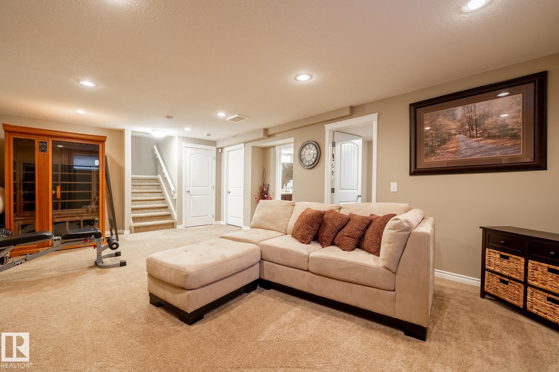 Recessed lighting illuminates this versatile lower-level space, featuring a carpeted floor, neutral wall tones, and white trim - 5820 7 Avenue Sw, Edmonton, AB - Indoor