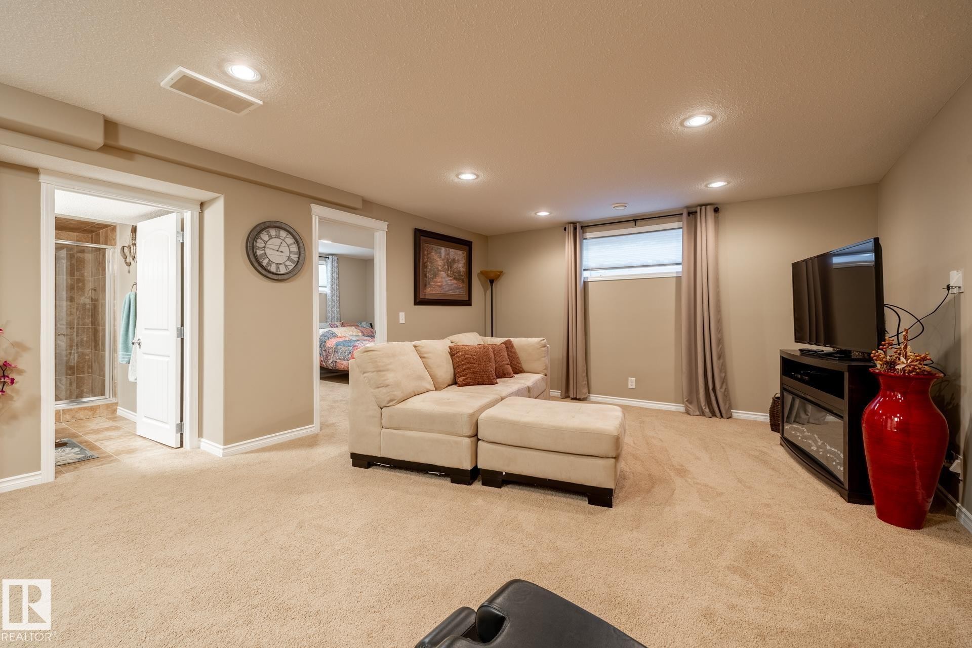 Spacious recreation room featuring recessed lighting, plush carpeting, and multiple doorways - 5820 7 Avenue Sw, Edmonton, AB - Indoor Photo Showing Basement