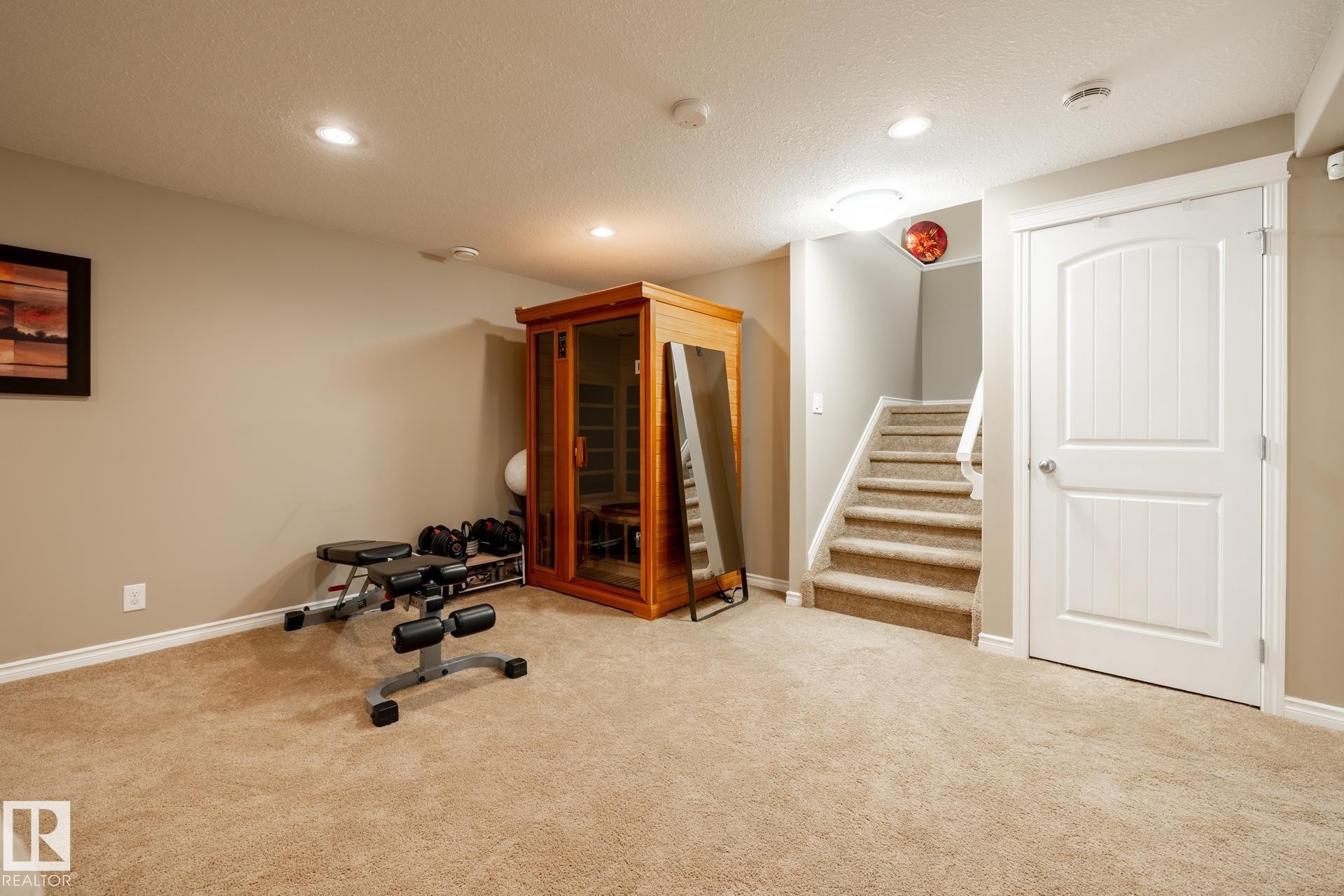 Carpeted room featuring recessed ceiling lights and a built-in sauna - 5820 7 Avenue Sw, Edmonton, AB - Indoor