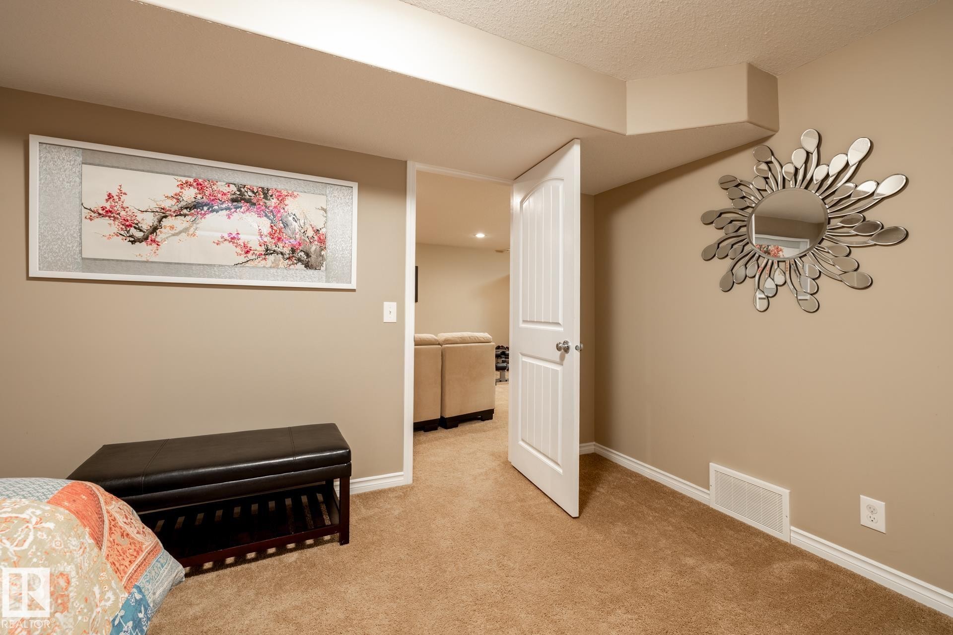 Neutral-toned carpeting extends throughout this interior space, complemented by light brown wall paint and white trim - 5820 7 Avenue Sw, Edmonton, AB - Indoor Photo Showing Other Room
