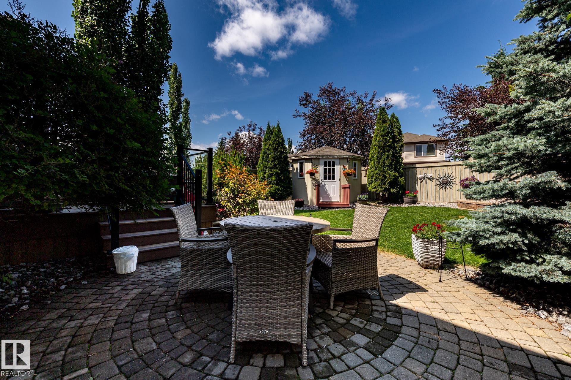 Circular paver patio featuring a stone walkway - 5820 7 Avenue Sw, Edmonton, AB - Outdoor With Deck Patio Veranda