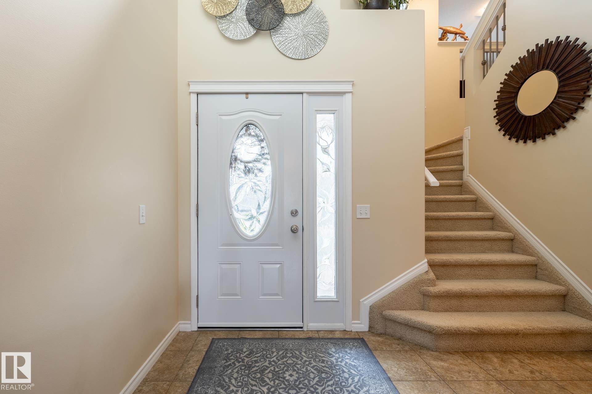 Entryway featuring a white door with an oval-shaped glass insert and a frosted sidelight - 5820 7 Avenue Sw, Edmonton, AB - Indoor Photo Showing Other Room