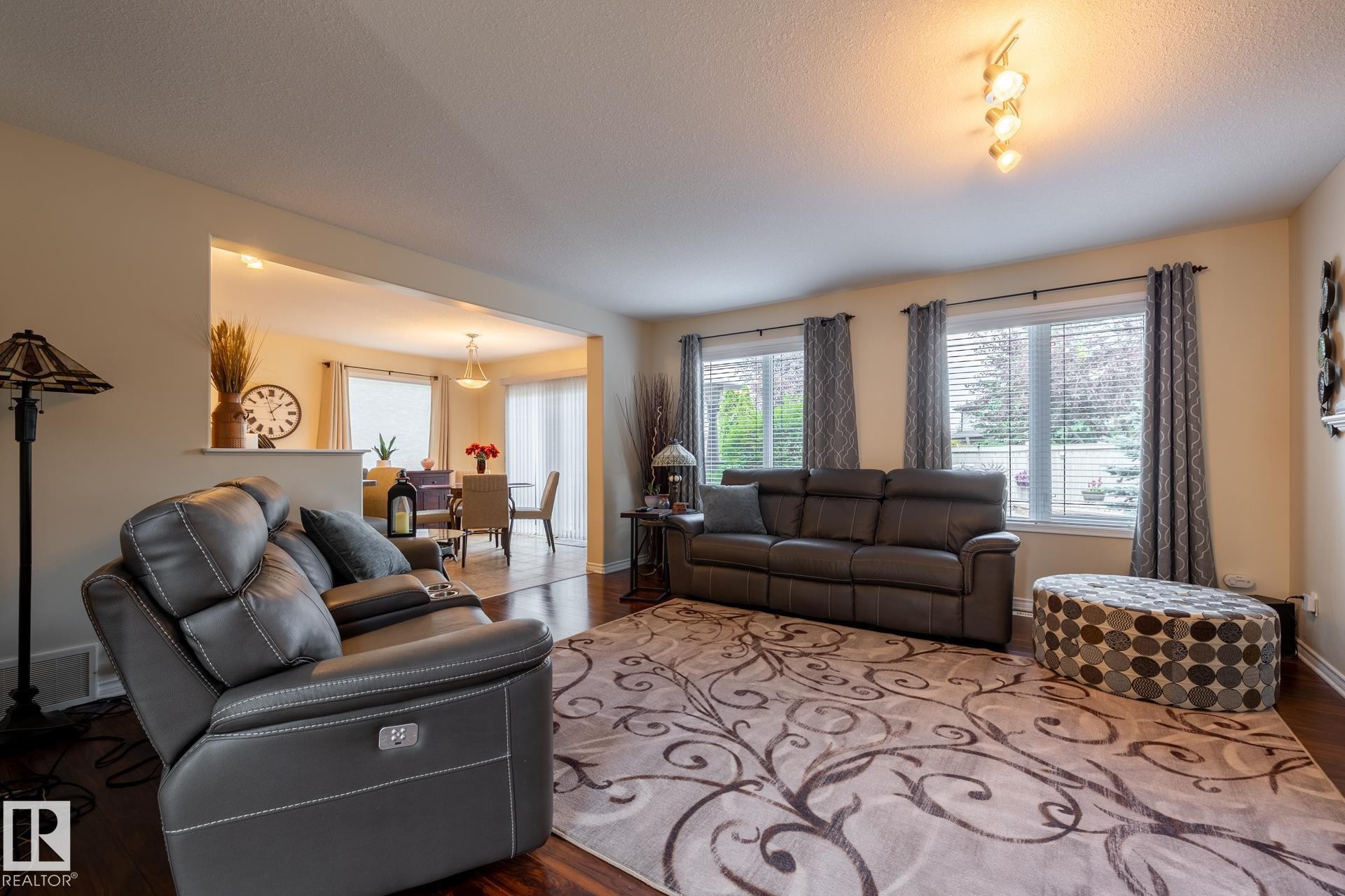 Open-concept living area featuring rich wood-finish flooring - 5820 7 Avenue Sw, Edmonton, AB - Indoor Photo Showing Living Room
