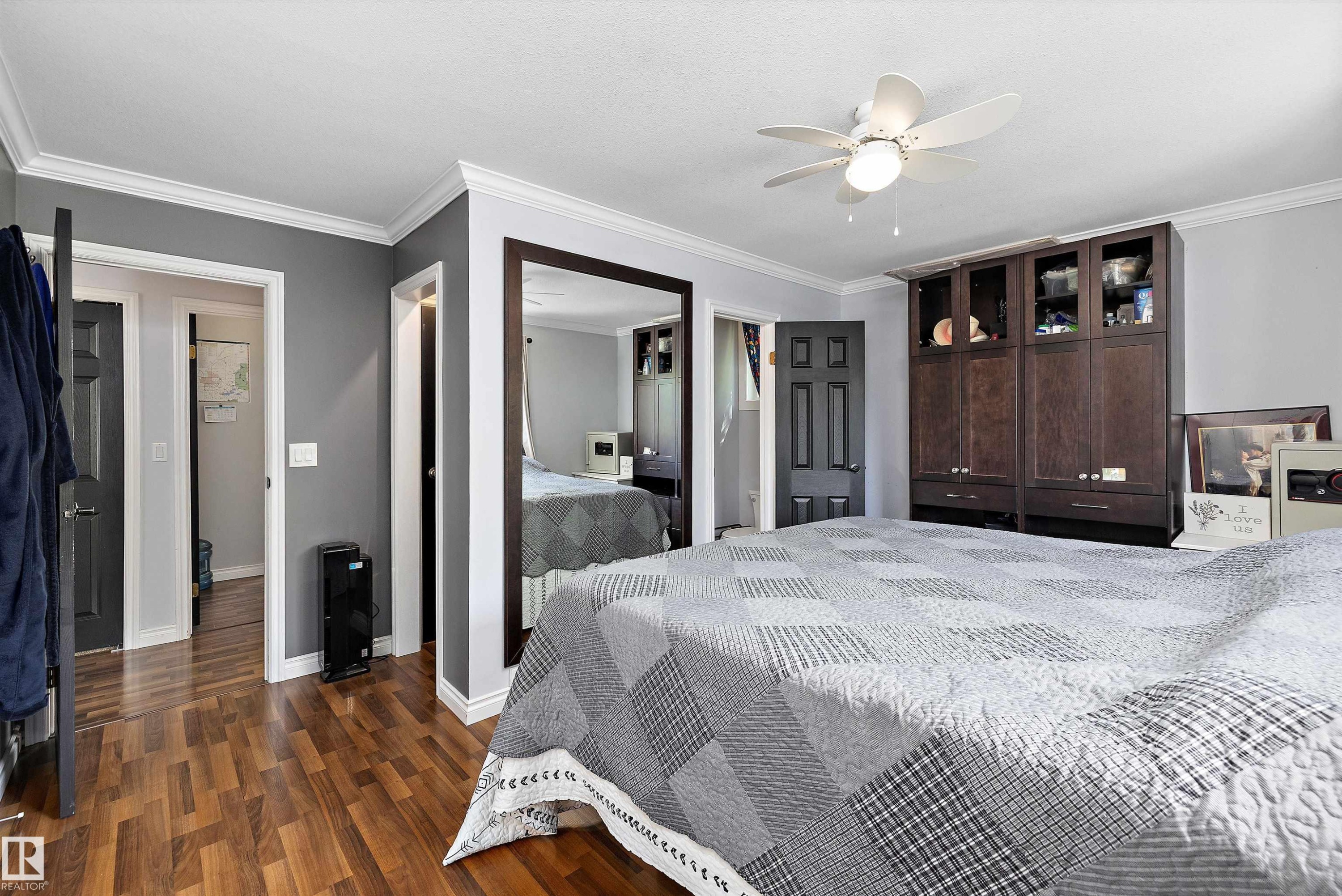 Interior room with wood-finish flooring, light gray walls, and white crown molding - 53257 Rge Road 211, Rural Strathcona County, AB - Indoor Photo Showing Bedroom