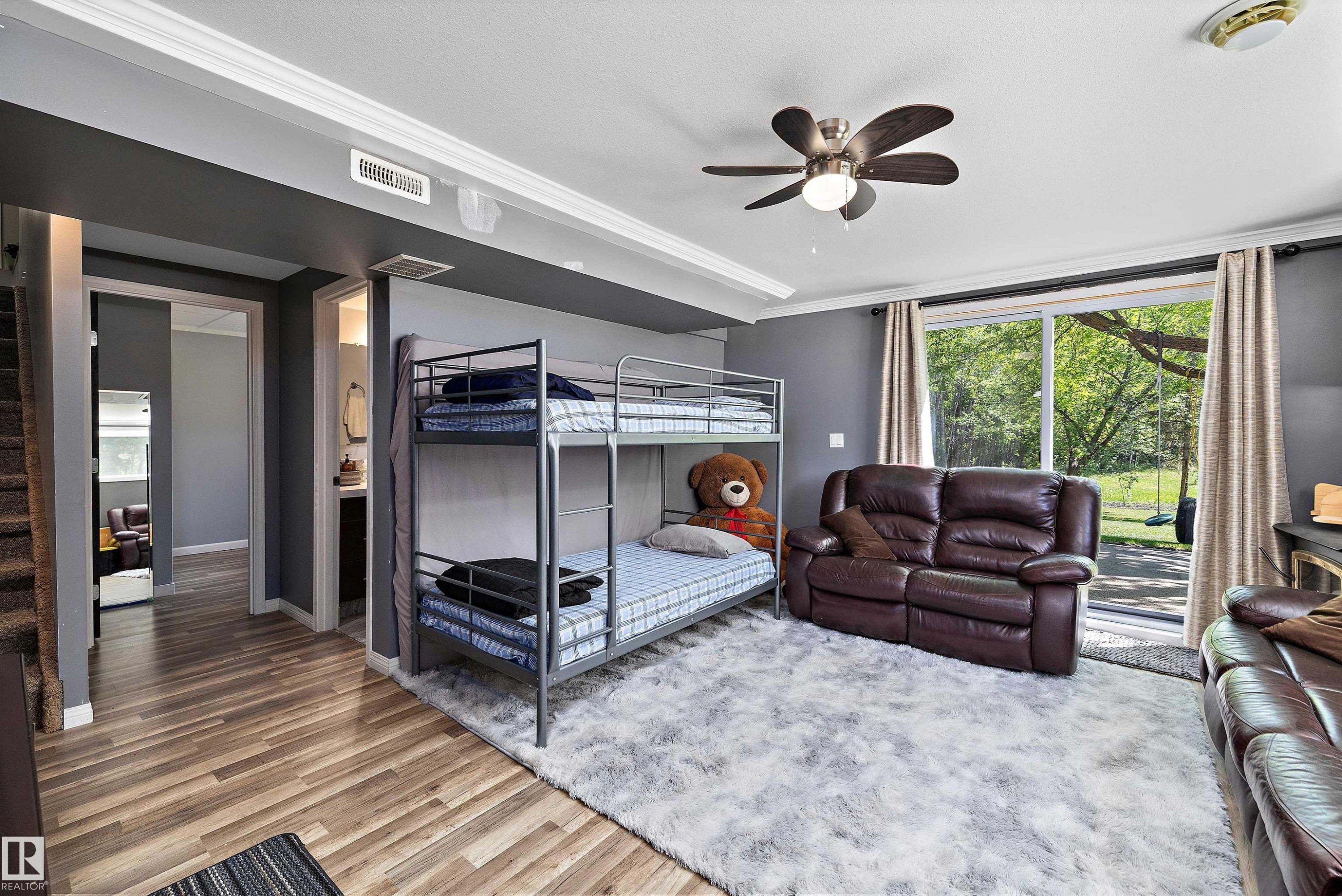 Open room featuring a ceiling fan, wood-finish flooring, sliding glass doors, and recessed lighting - 53257 Rge Road 211, Rural Strathcona County, AB - Indoor