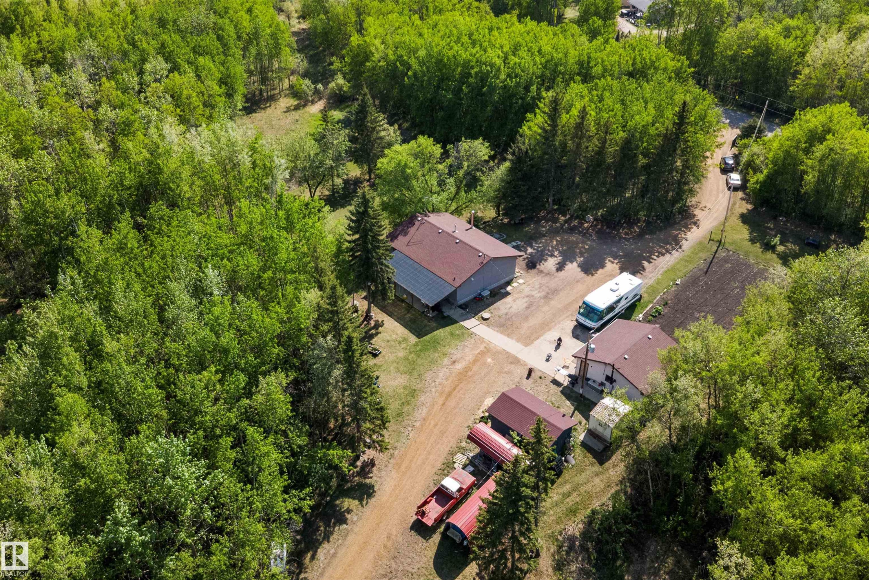 Expansive property featuring multiple structures, surrounded by abundant mature trees - 53257 Rge Road 211, Rural Strathcona County, AB - Outdoor With View
