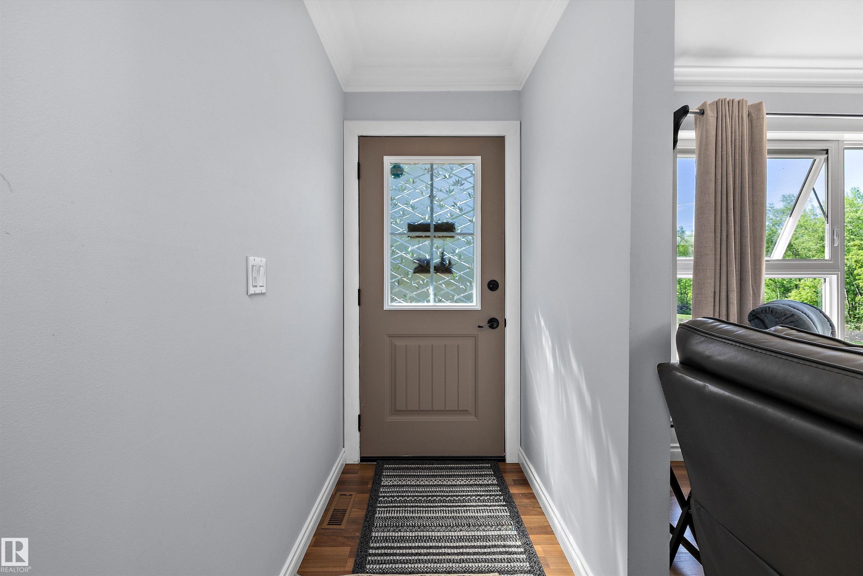 Entryway featuring a decorative glass panel door, wood-finish flooring, light grey walls, white baseboards, and crown molding - 53257 Rge Road 211, Rural Strathcona County, AB - Indoor Photo Showing Other Room