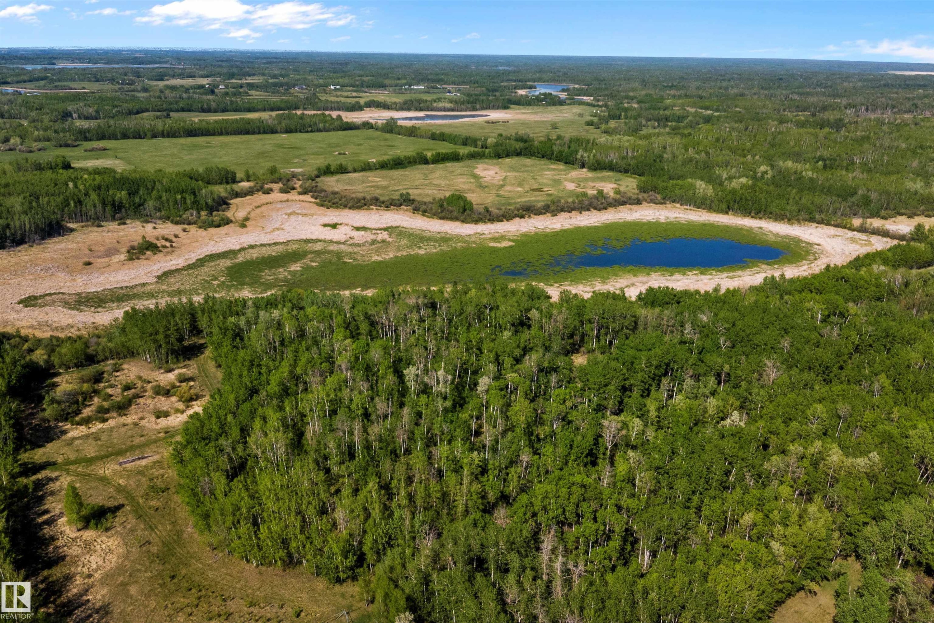 Expansive natural landscape featuring a prominent body of water bordered by varied terrain - 53257 Rge Road 211, Rural Strathcona County, AB - Outdoor With View