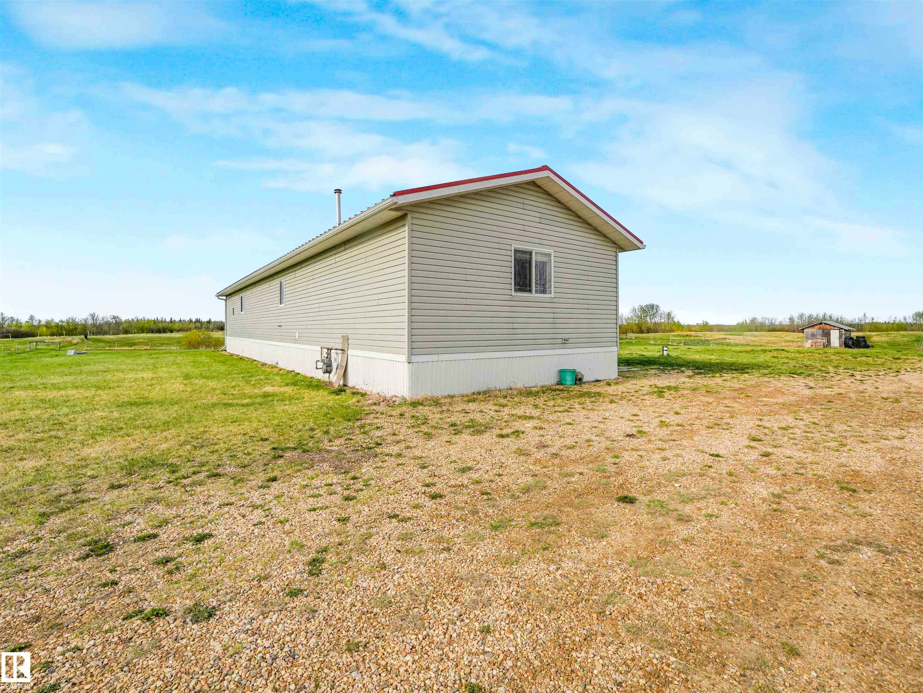 Single-story residence featuring light gray siding, a red roof, and white trim - 57016 Range Road 13, Rural Barrhead County, AB - Outdoor With Exterior