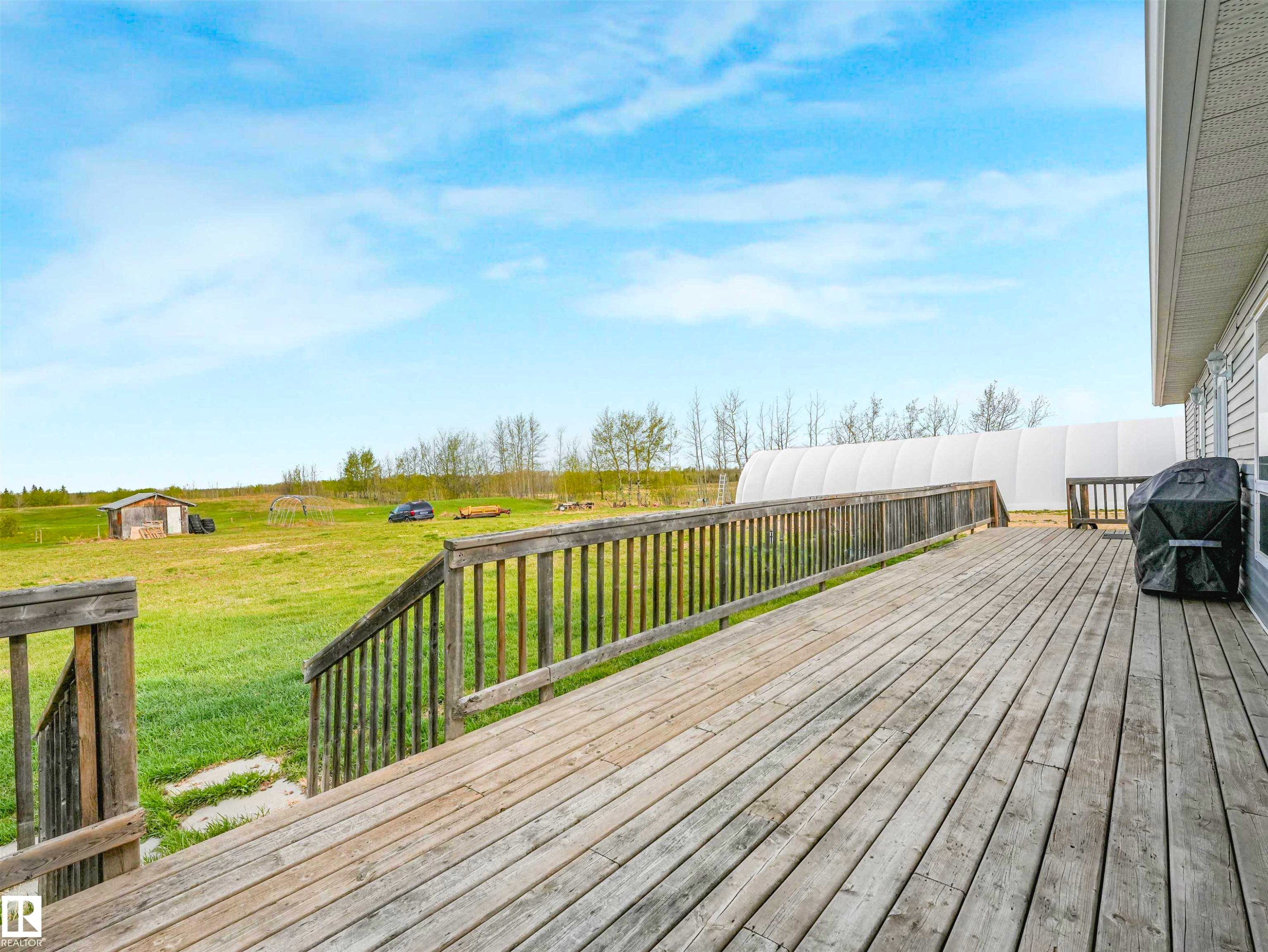Expansive outdoor deck featuring wood-finish decking and perimeter railings - 57016 Range Road 13, Rural Barrhead County, AB - Outdoor With Deck Patio Veranda
