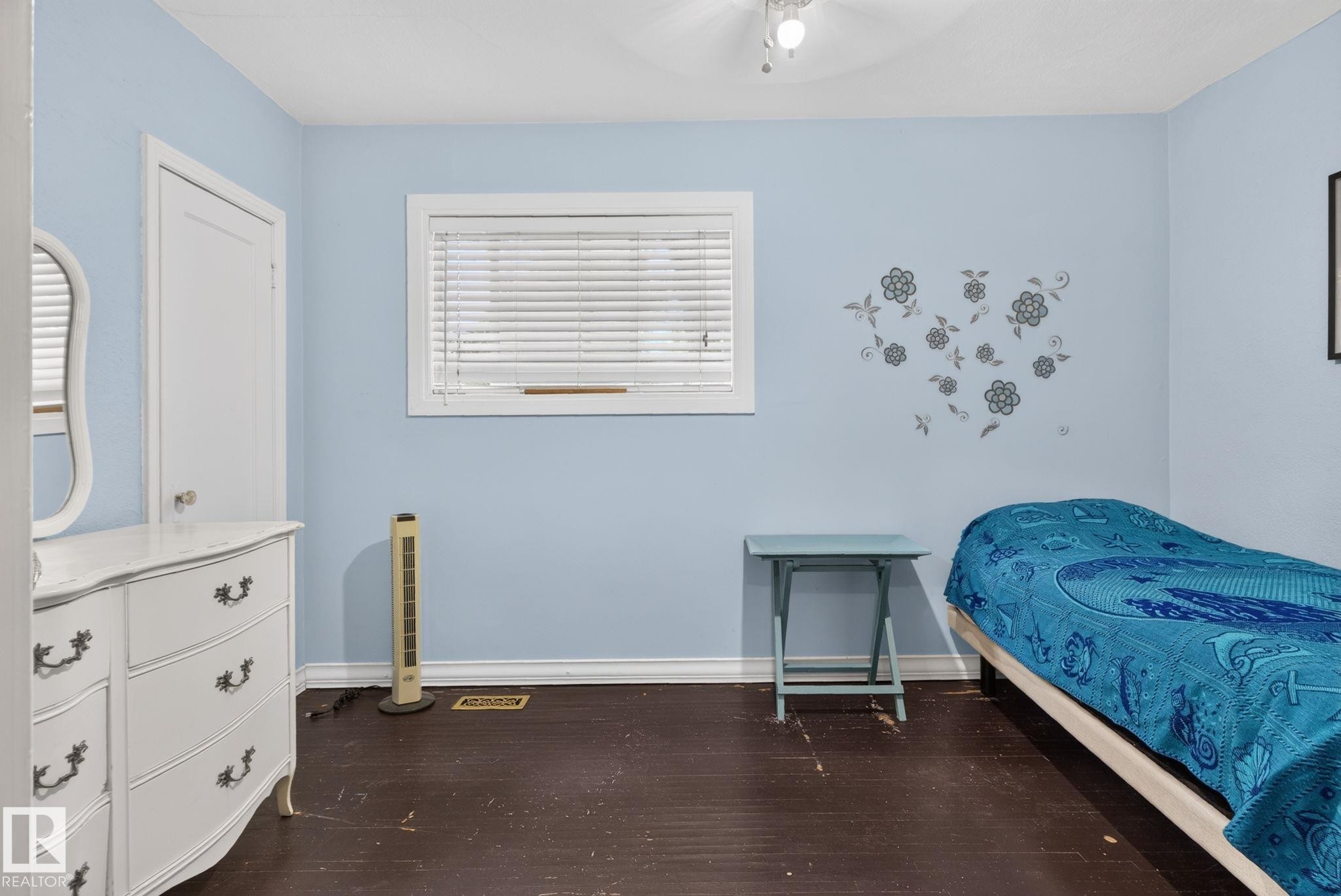 Interior room featuring light blue painted walls and dark wood-finish flooring - 12703 122 Street Nw, Edmonton, AB