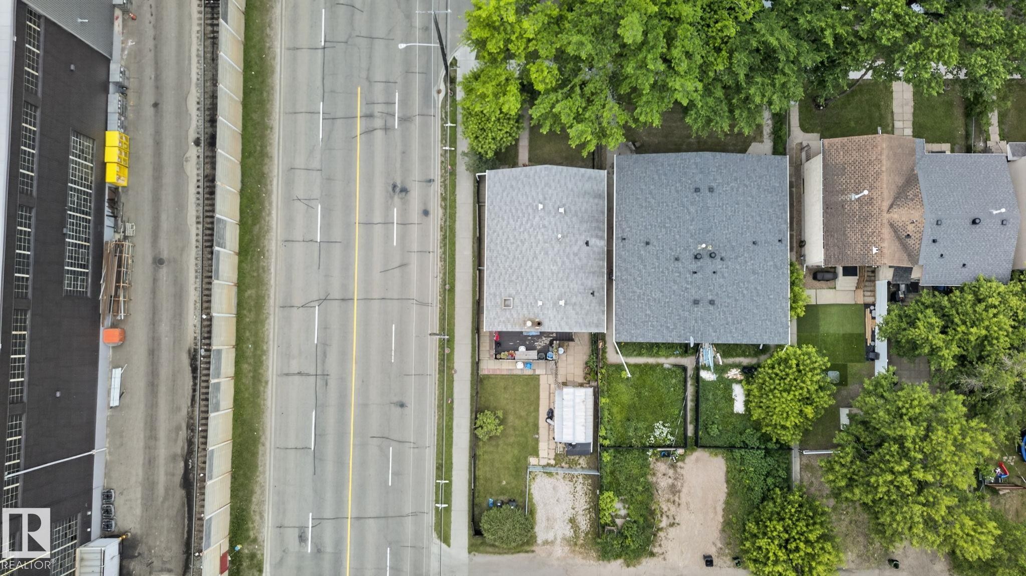Aerial overview featuring multiple residential properties with shingle roofs - 12703 122 Street Nw, Edmonton, AB