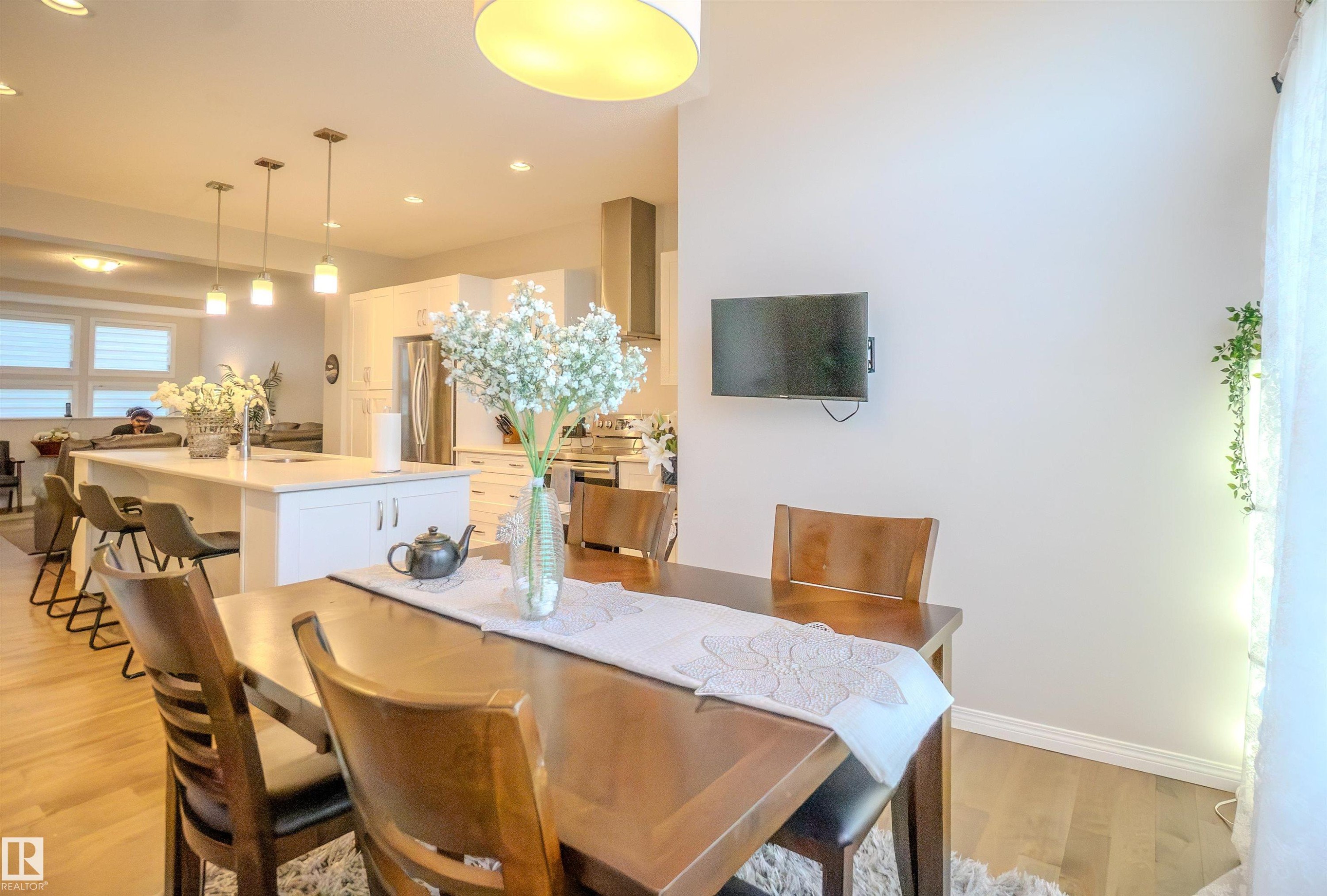 Open-concept interior featuring wood-finish flooring - 1766 Dumont Crescent Sw, Edmonton, AB - Indoor Photo Showing Dining Room