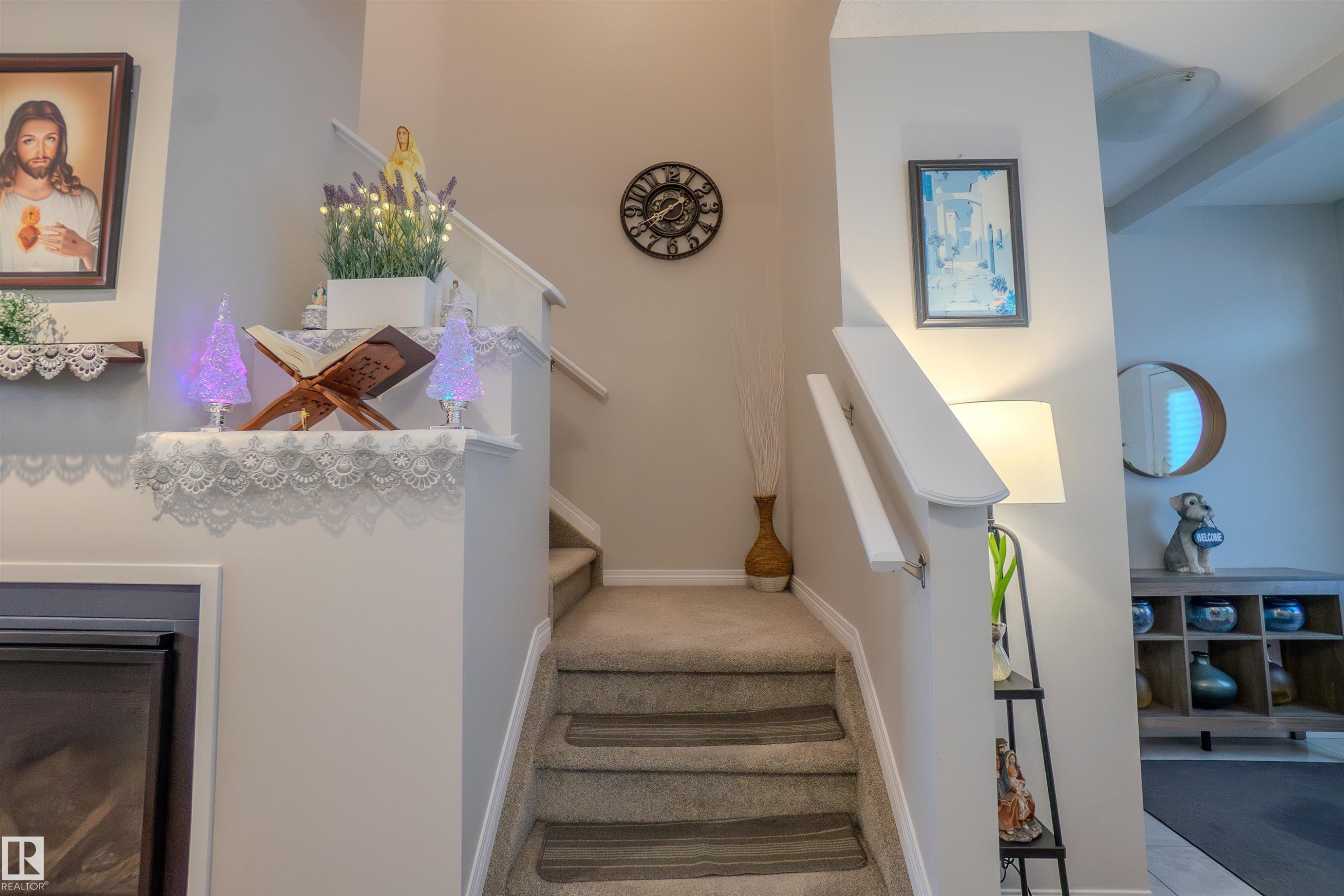 Carpeted staircase with white handrails and neutral wall tones - 1766 Dumont Crescent Sw, Edmonton, AB - Indoor Photo Showing Other Room