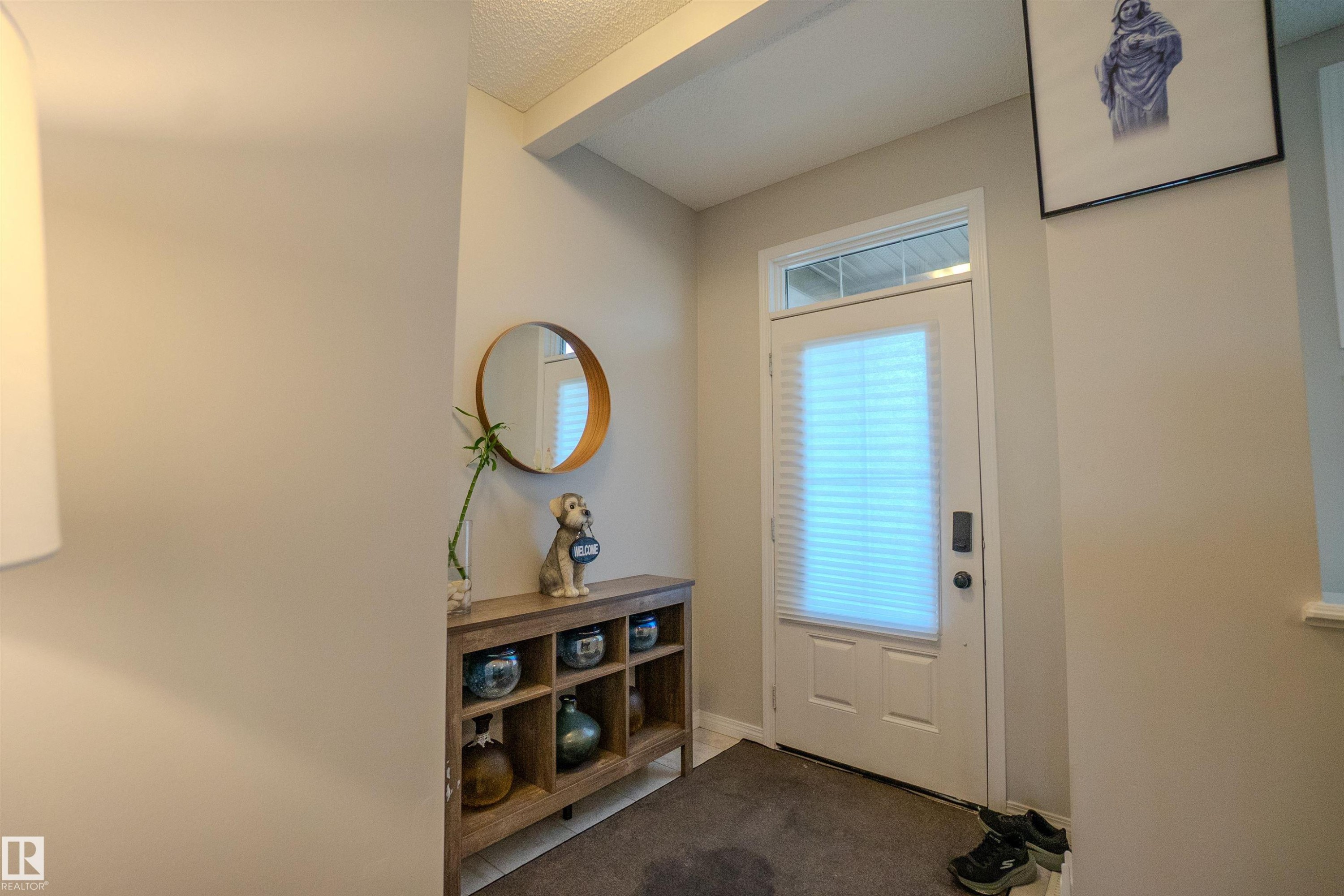 Entryway featuring a white door with an integrated window blind, transom window, and a dark floor mat - 1766 Dumont Crescent Sw, Edmonton, AB - Indoor Photo Showing Other Room